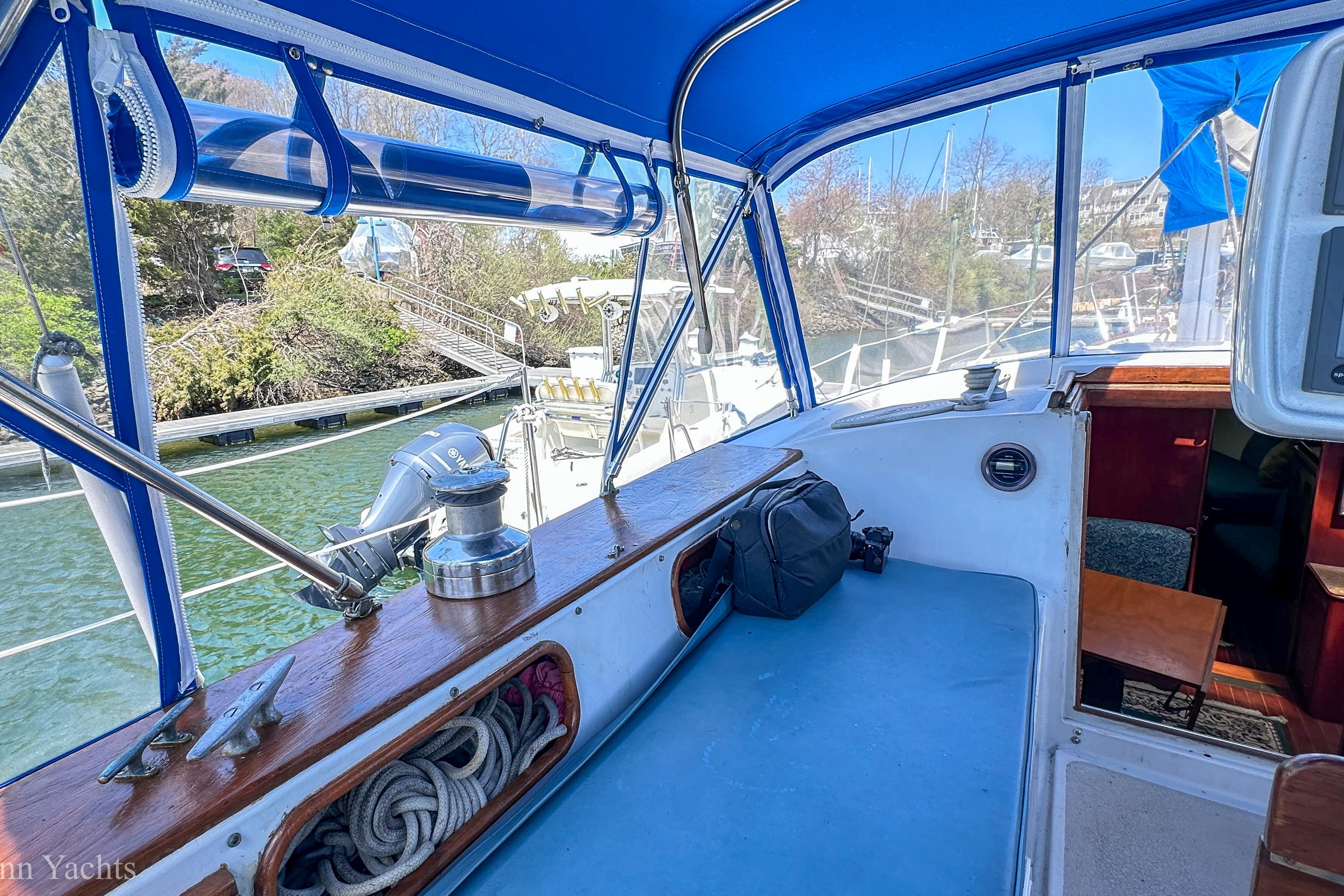 Cockpit of 1980 Irwin 46 sailboat with blue canopy and dockside view.