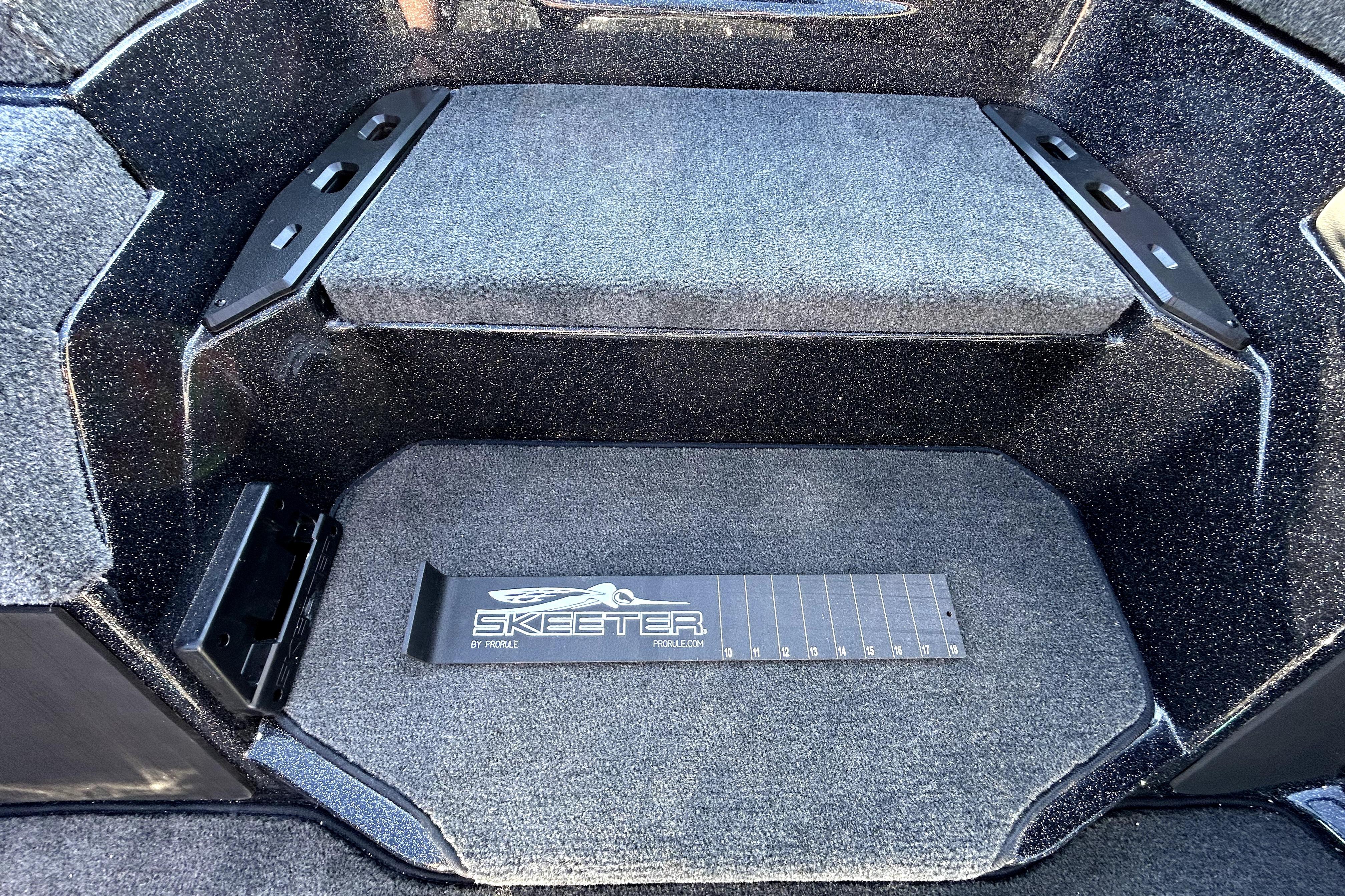 Interior of 2026 Skeeter ZXE21 boat with carpeted flooring and branded measuring board.