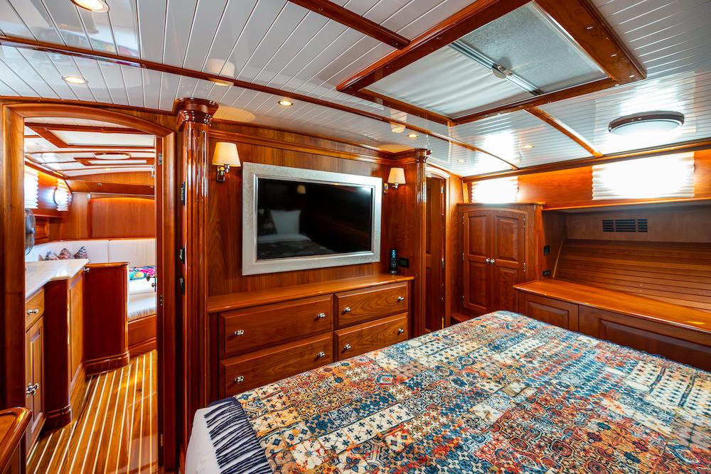 Luxurious cabin interior of 2021 Hinckley Talaria 55 Flybridge MKII yacht with wood finish.
