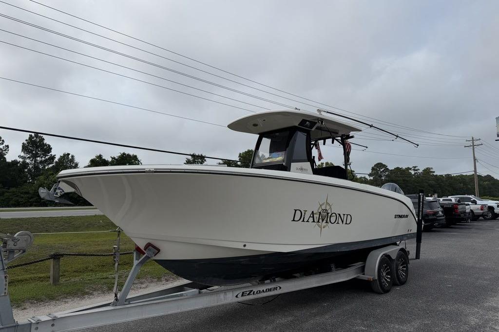 2023 Stingray 273 CC boat named "Diamond" on a trailer, parked outdoors.