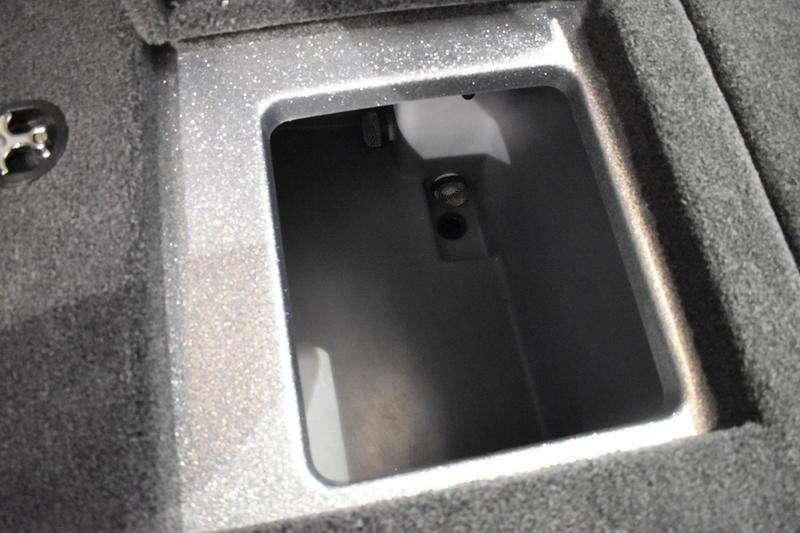 Storage compartment in 2026 Triton 18 TrX boat, featuring carpeted interior.