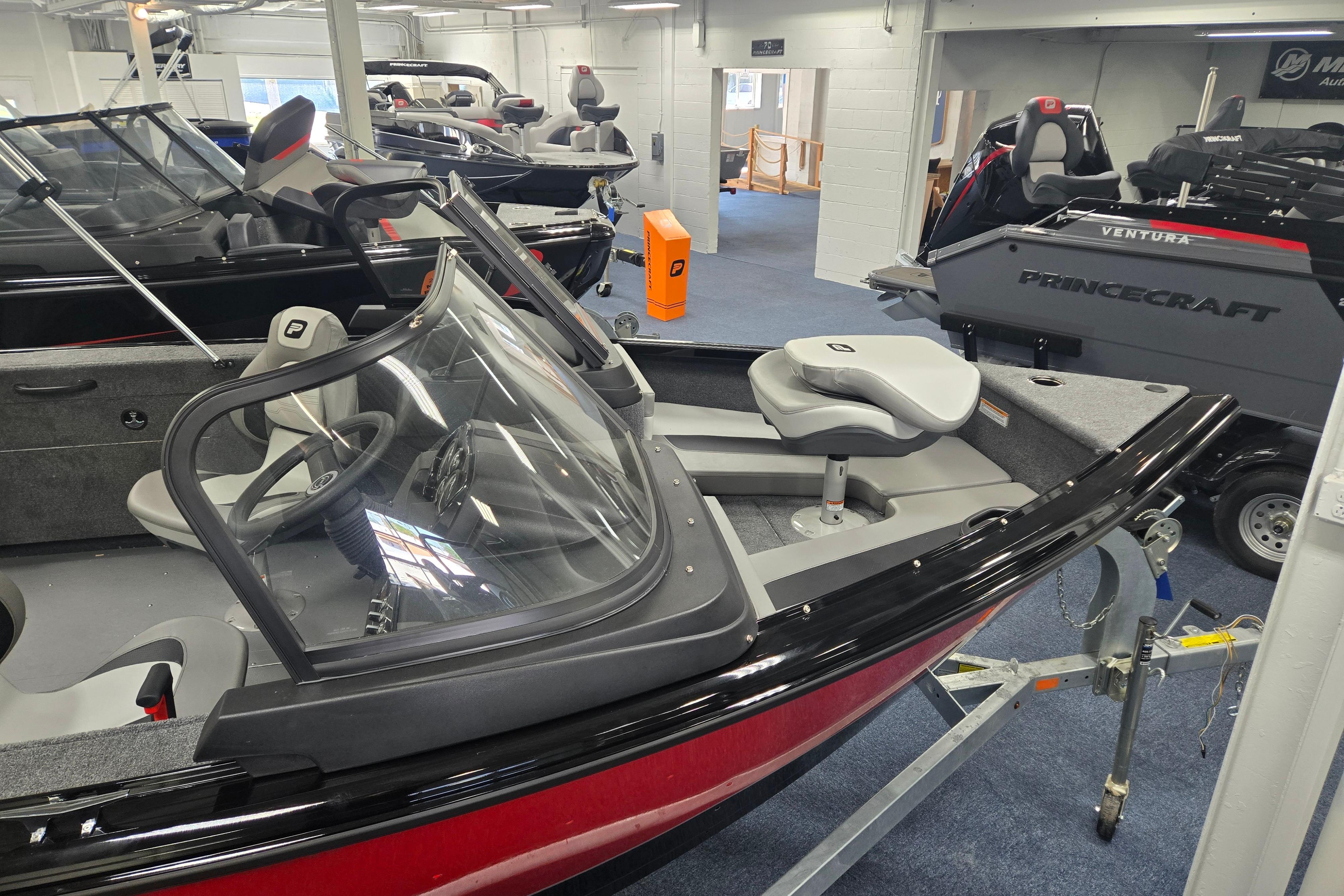 2026 Princecraft Sport 175 MAX boat displayed in showroom, featuring sleek design and modern seating.