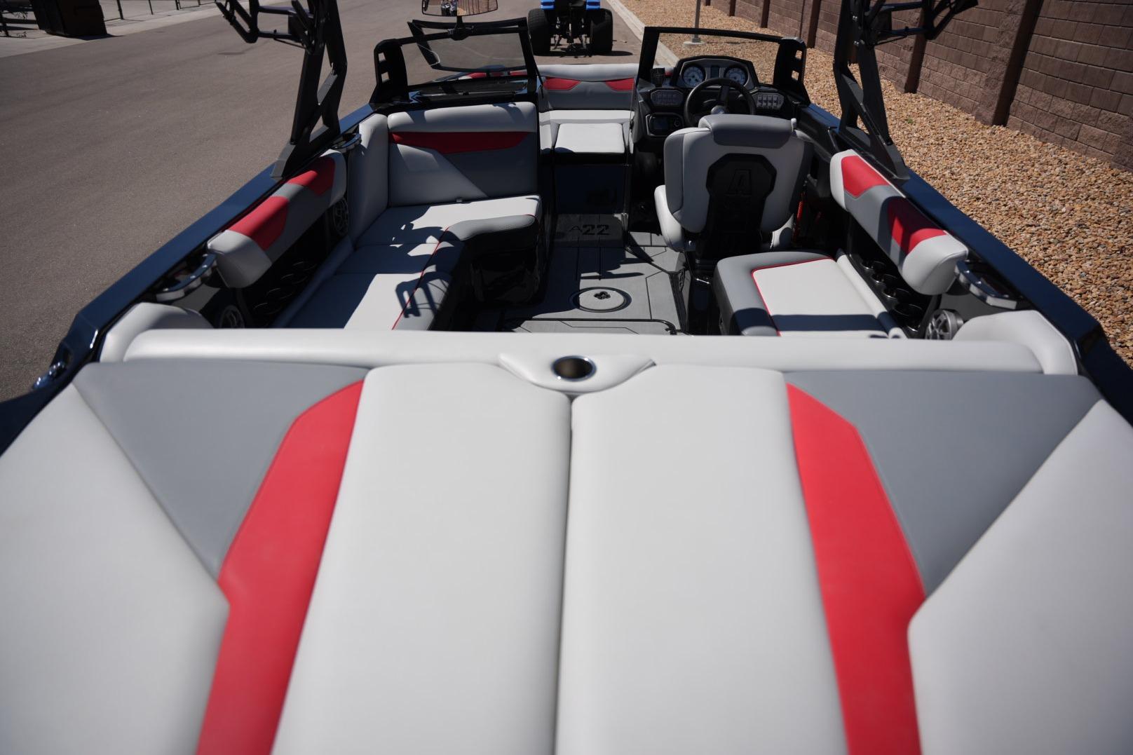 2019 Axis A22 boat interior with red and gray seating, steering console, and open layout.