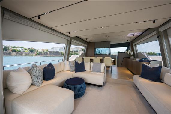 Luxurious interior of 2023 Ferretti Yachts 720 with elegant seating and panoramic windows.