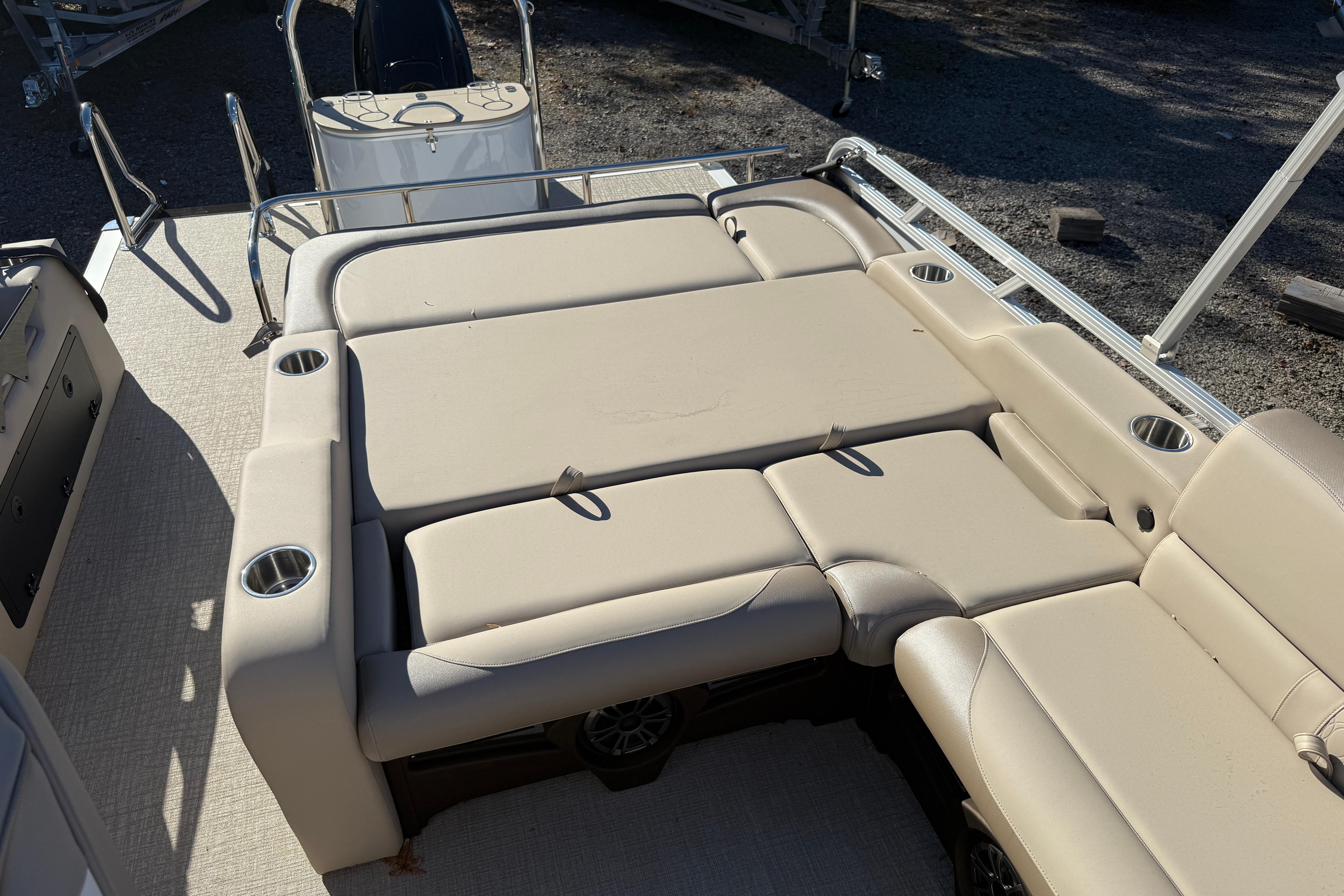 2026 Tahoe Pontoon LTZ Versatile Rear Lounger with beige seating and cup holders.