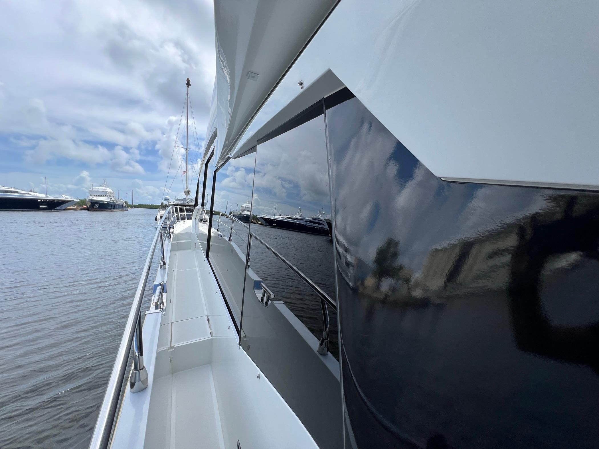 Galeon 680 Fly yacht, 2020 model, docked with sleek design and reflective surfaces.