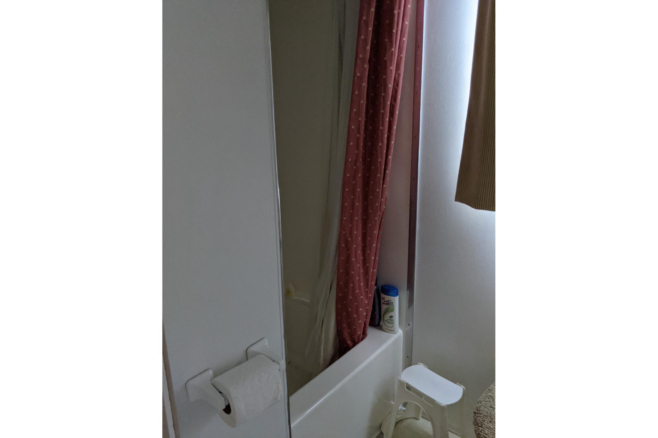 Bathroom interior of 2001 Gibson 50 Cabin Yacht with shower and curtain.