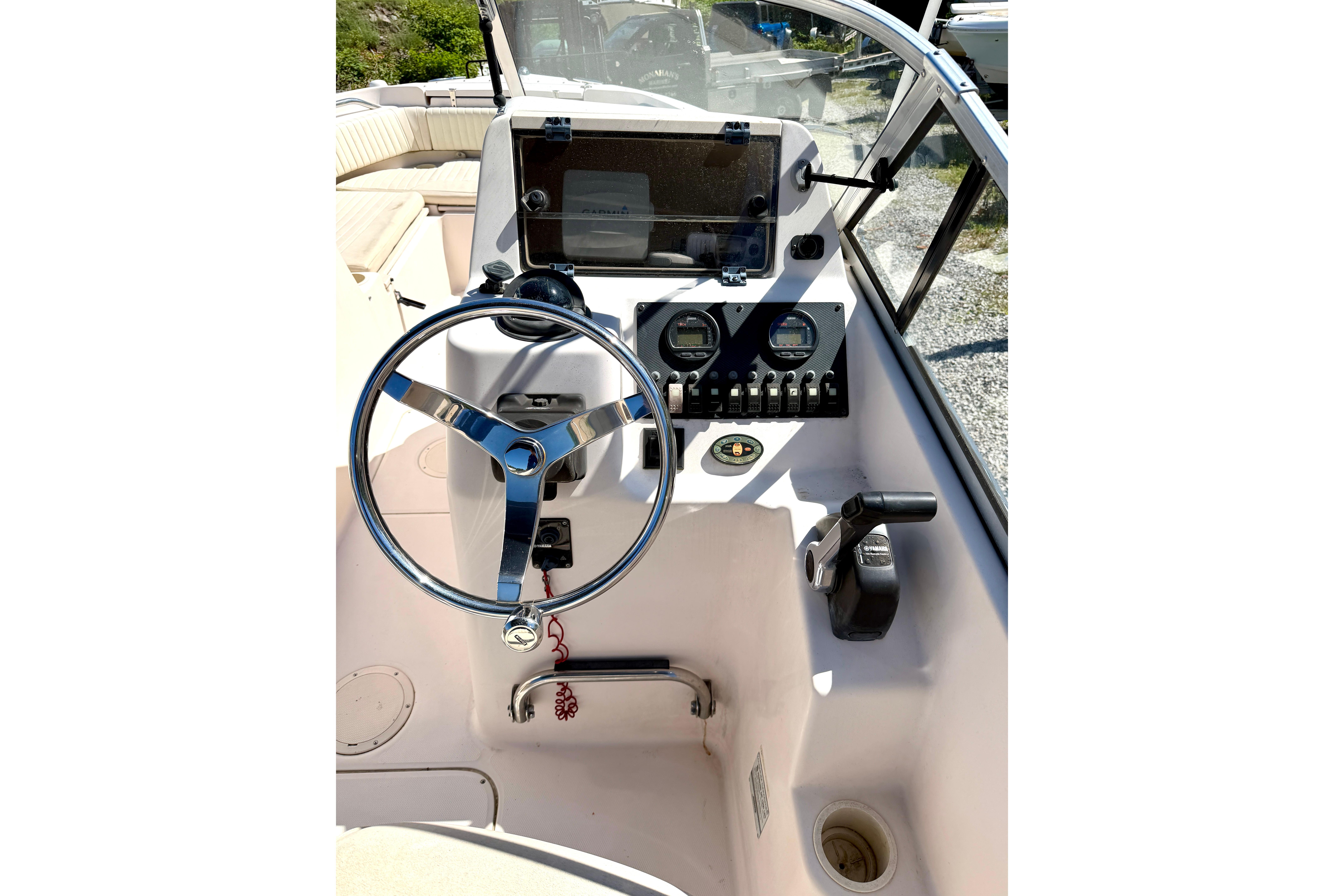 2005 Grady-White Freedom 225 boat dashboard with steering wheel and control panel.
