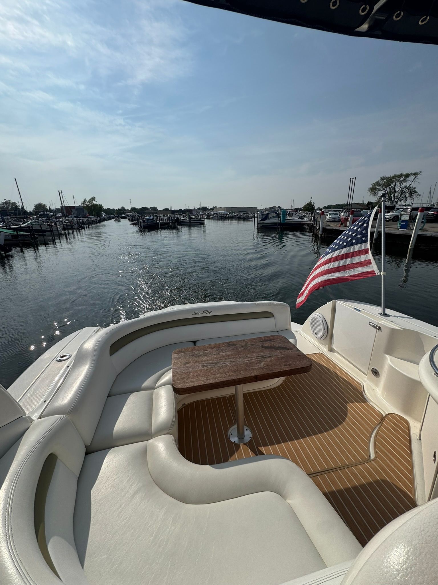2007 Sea Ray 340 Sundancer with American flag in harbor.