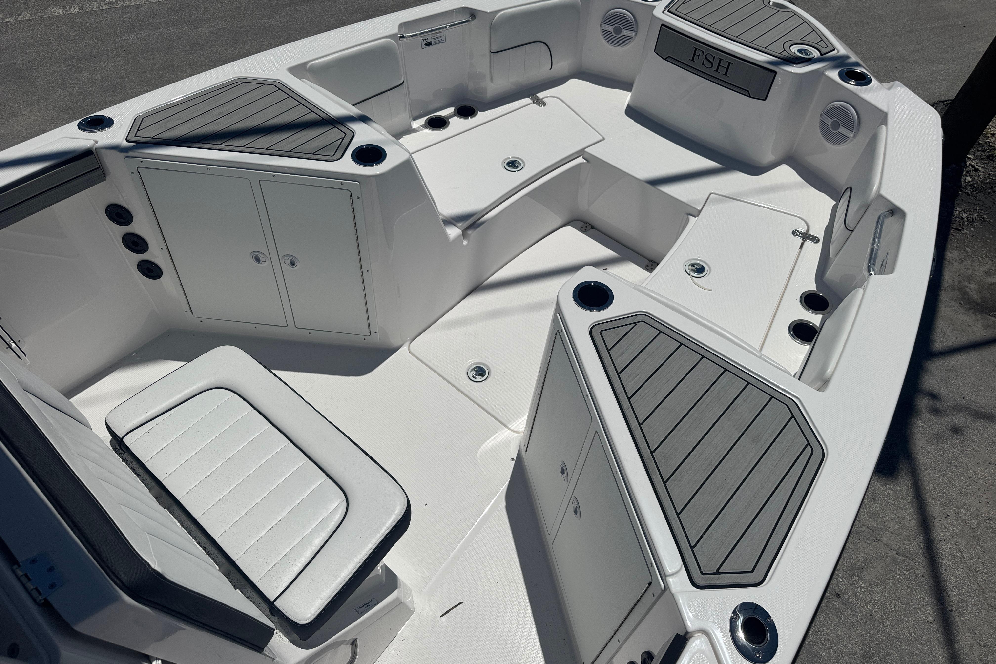 2026 Yamaha Boats 220 FSH Sport interior with seating and storage compartments.