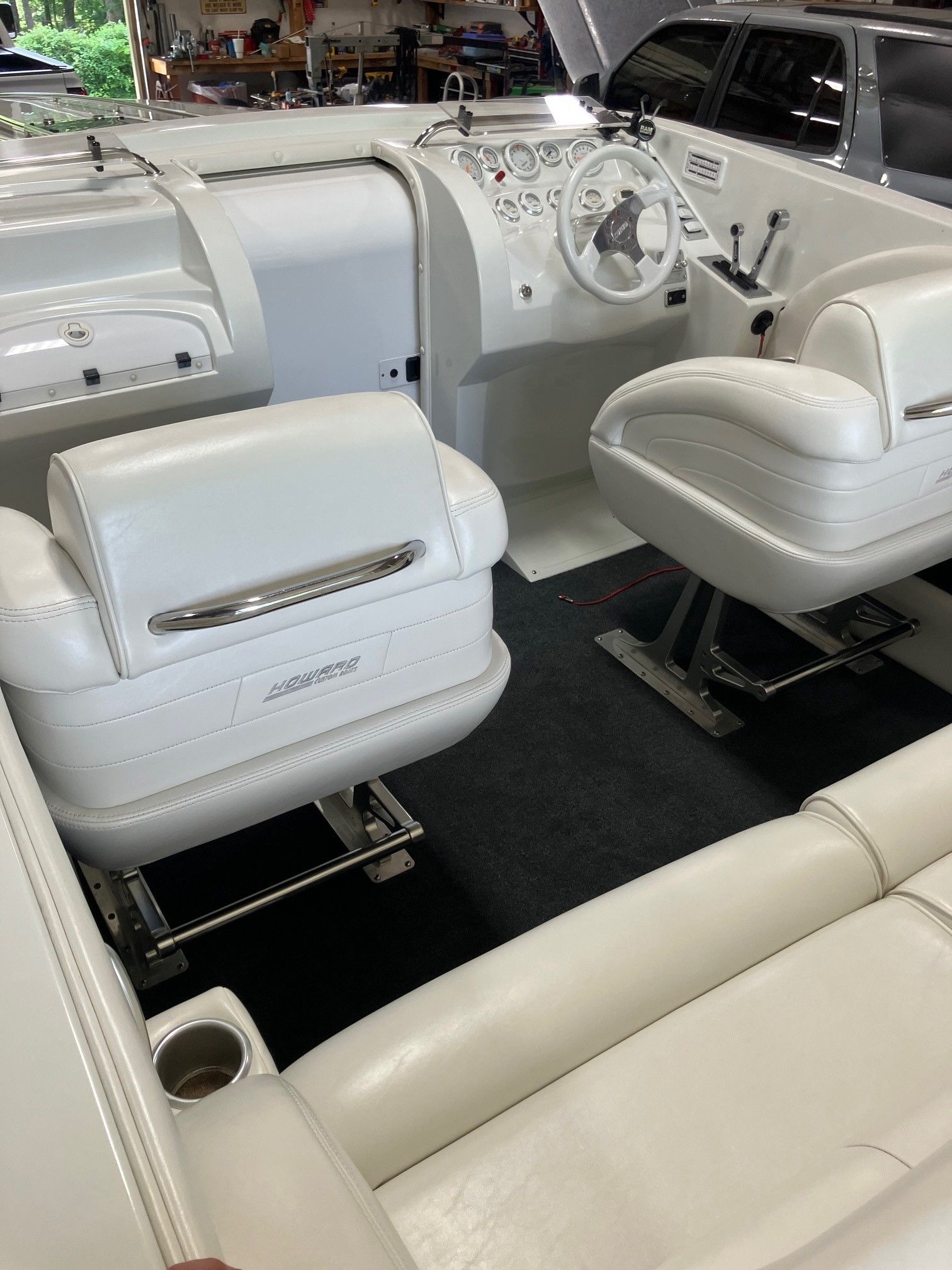 Interior of a 2003 Howard Bullet boat with white leather seats and a modern dashboard.