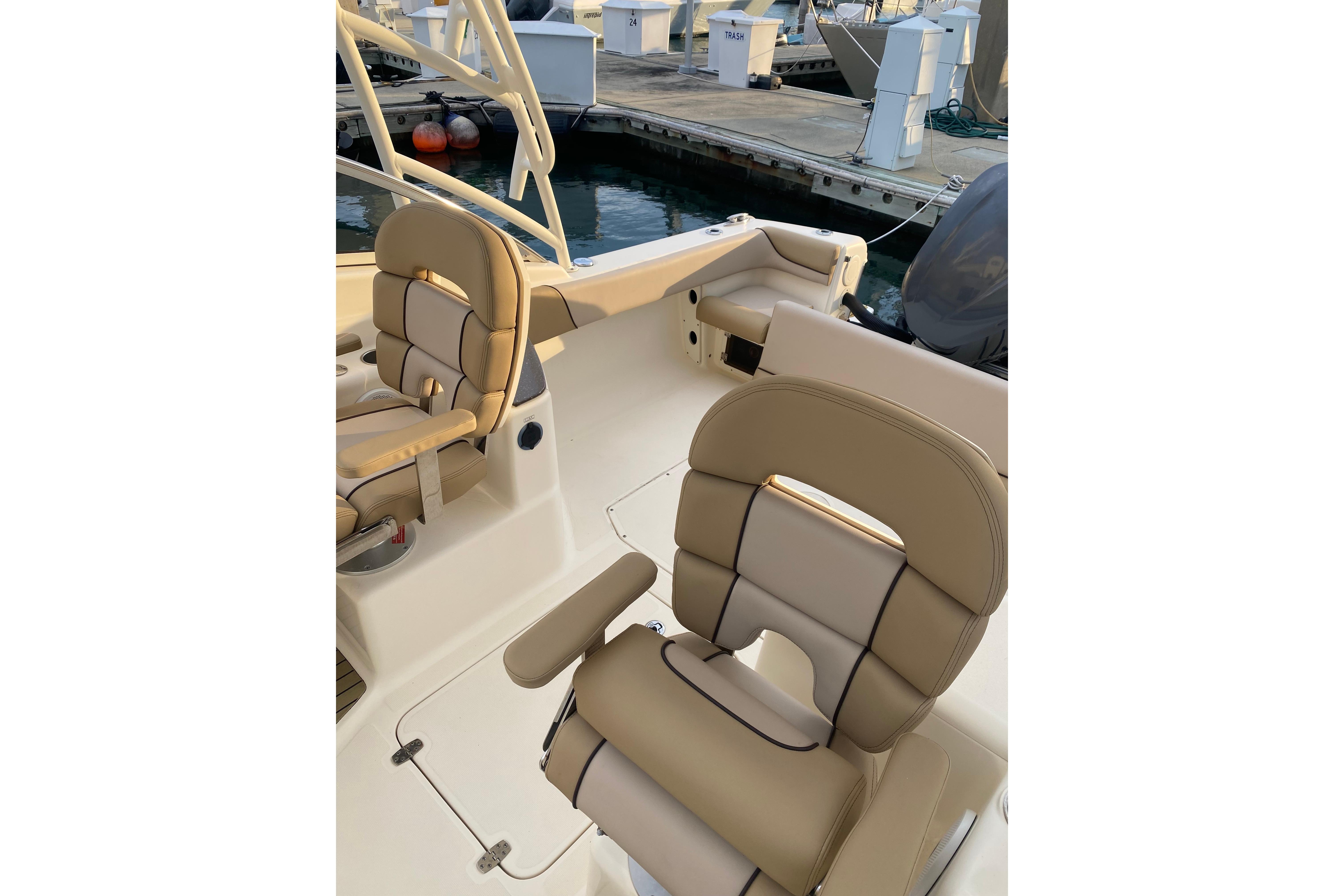 2016 Scout 245 Dorado boat interior with beige seating at marina.