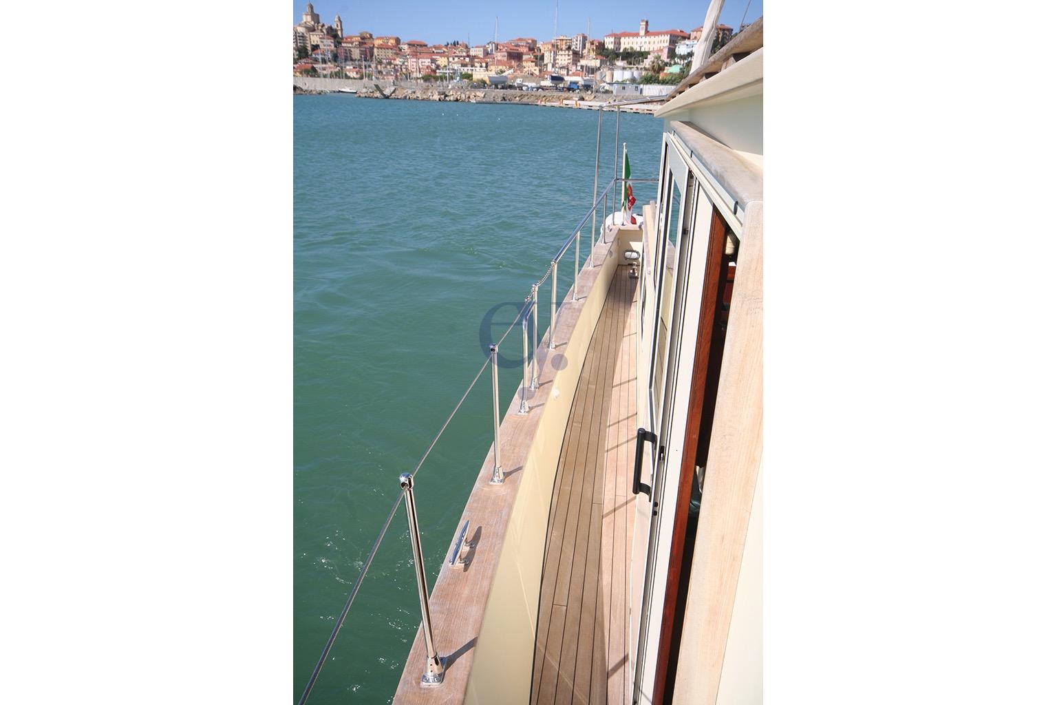 Deck view of 2012 Sibma Navale Italiana Armstrong 12 yacht near coastal town.