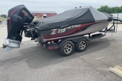 2023 Nitro ZV19 Sport boat with cover on trailer, parked outdoors.
