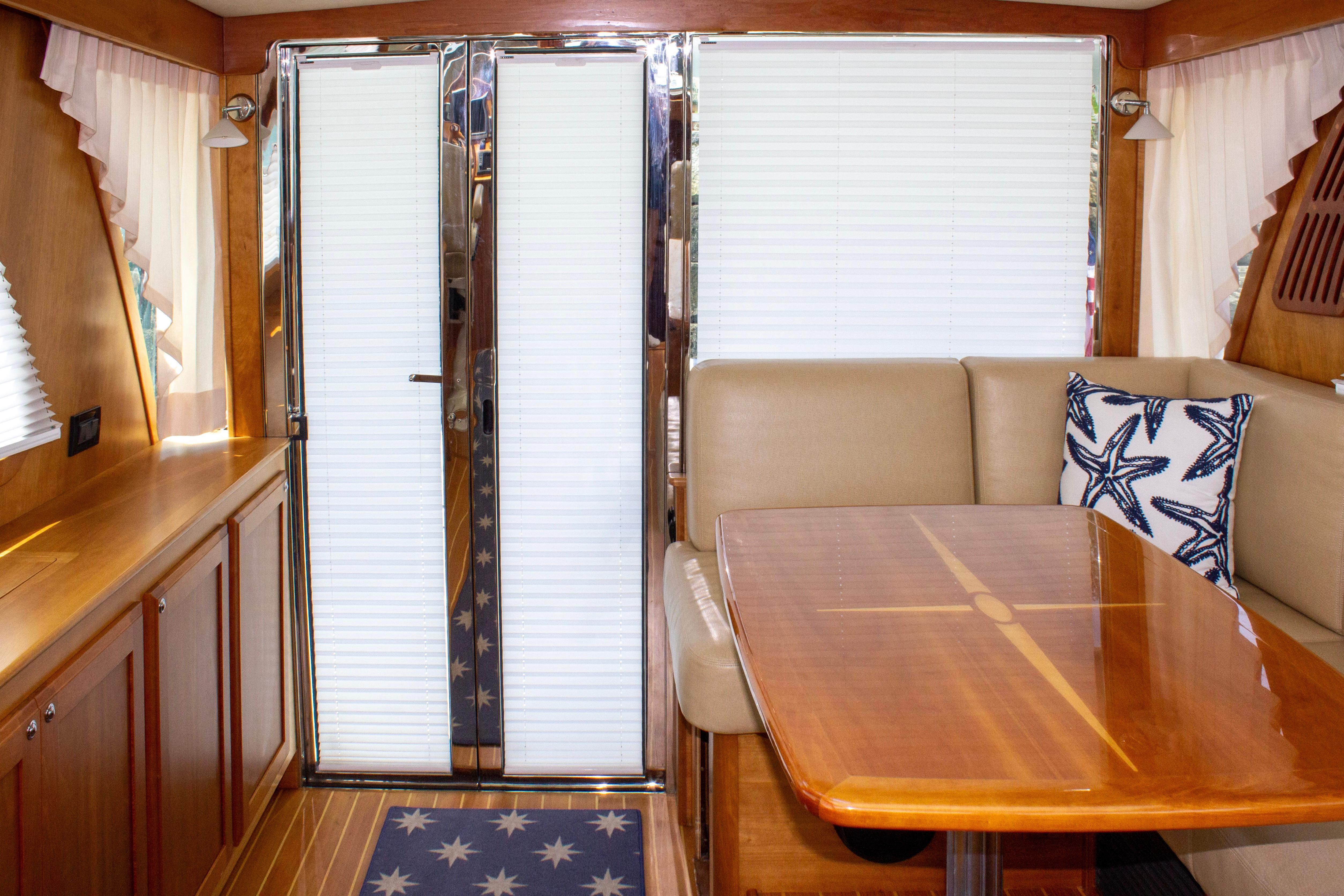 Interior of 2013 Sabre 38 Salon Express with wooden table and starfish pillow.