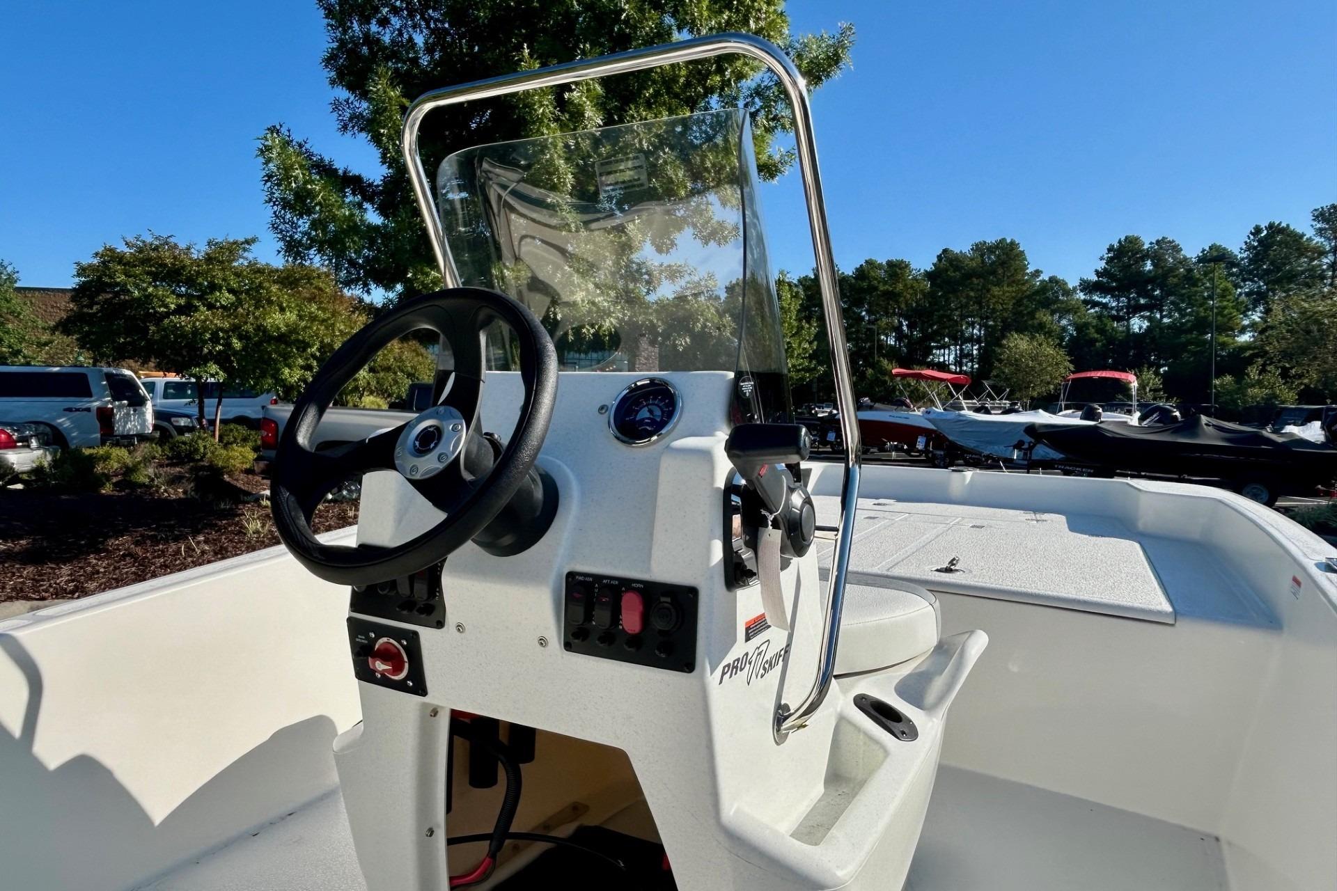 2026 Mako Pro Skiff 17 CC boat interior with steering wheel and console.