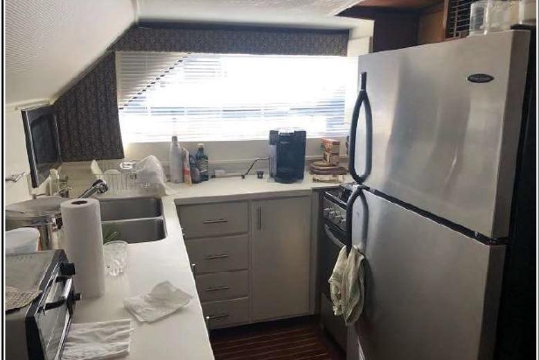 1974 Pacemaker Cockpit Motoryacht kitchen with modern appliances and ample counter space.