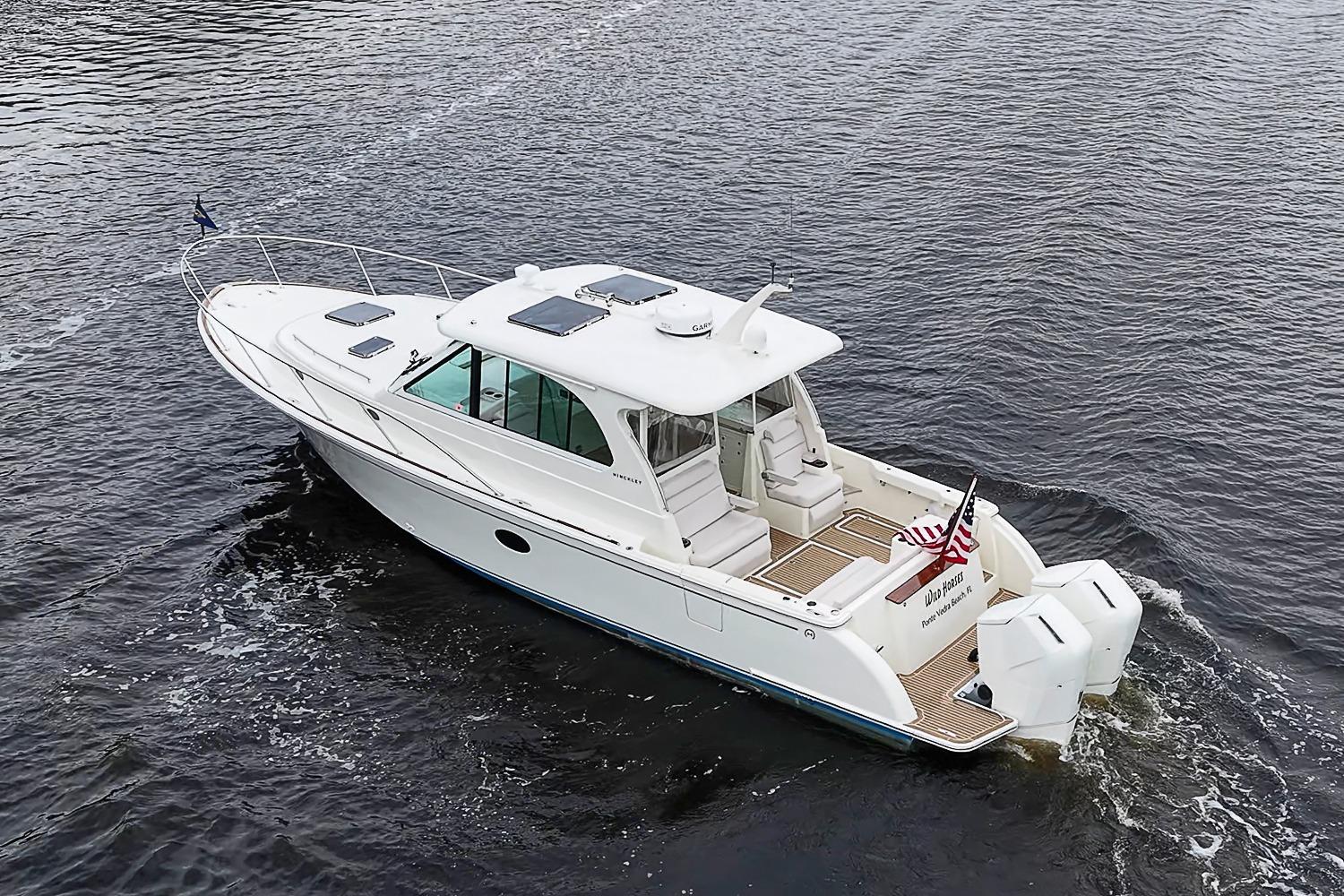 2023 Hinckley Sport Boat 40 X cruising on open water, rear view.