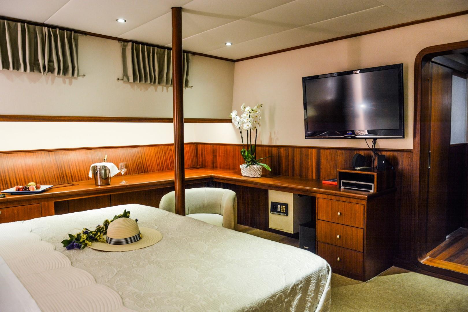 Luxurious cabin interior of 2007 Custom 34m Steel Hull Gulet with TV and elegant decor.
