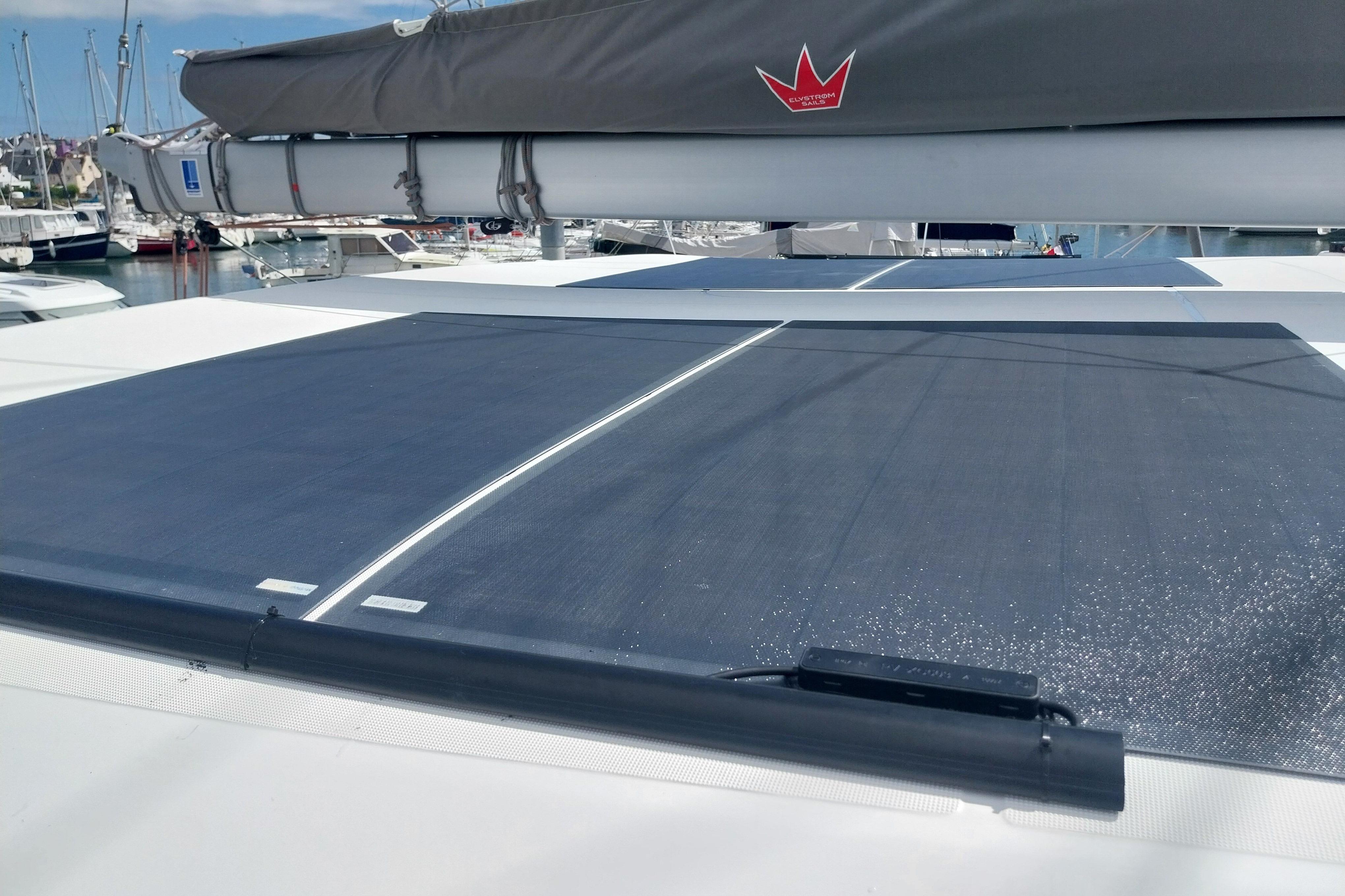 2024 Excess EXCESS 14 yacht with solar panels on deck, docked at marina.