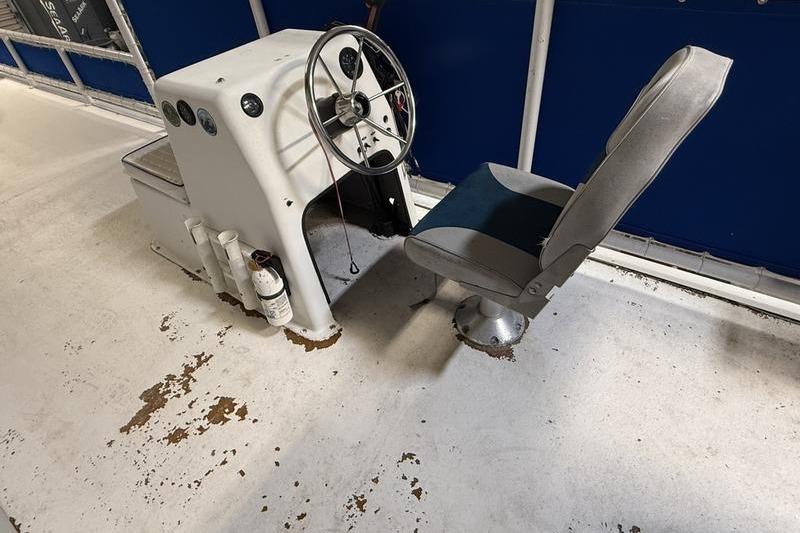 1993 Monark Sun Caster 240 CR 4 Point boat helm with steering wheel and seat.