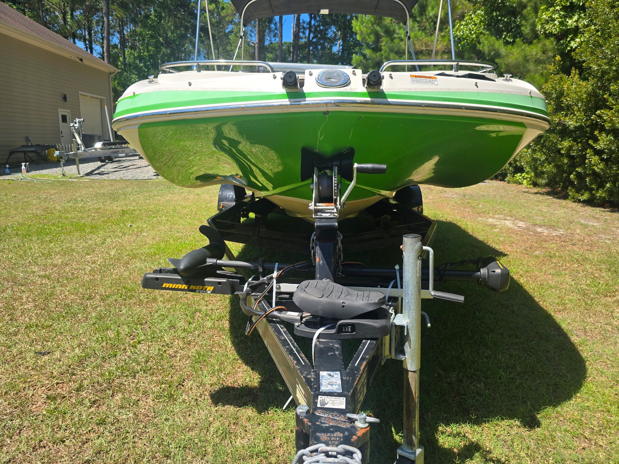 A green 2017 Starcraft MDX 191 OB boat on a trailer outdoors.