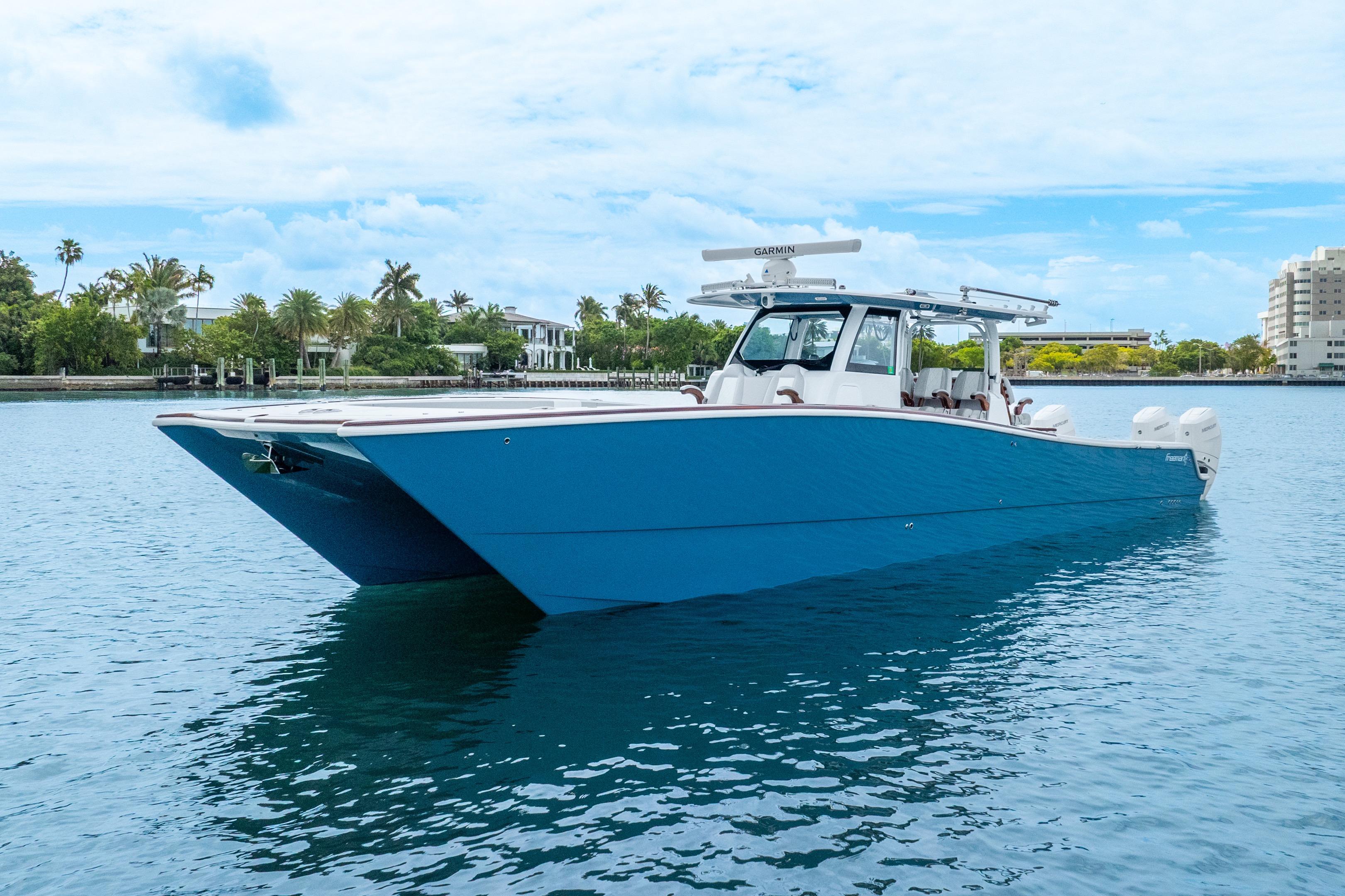 2024 Freeman 47 boat on calm water, featuring a sleek blue design.