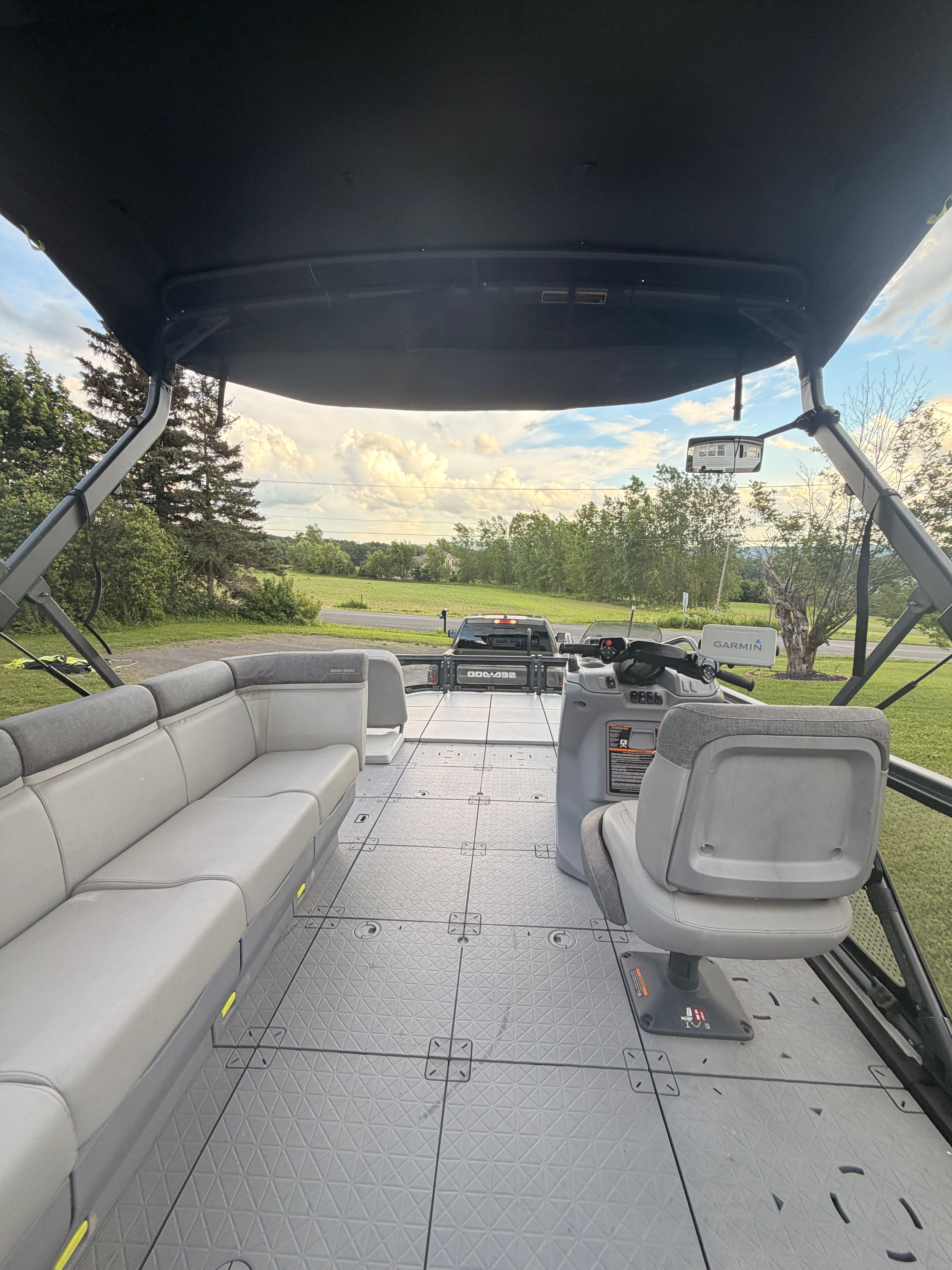 Interior view of a 2023 Sea-Doo Switch Sport 21 with gray seating and a helm console.