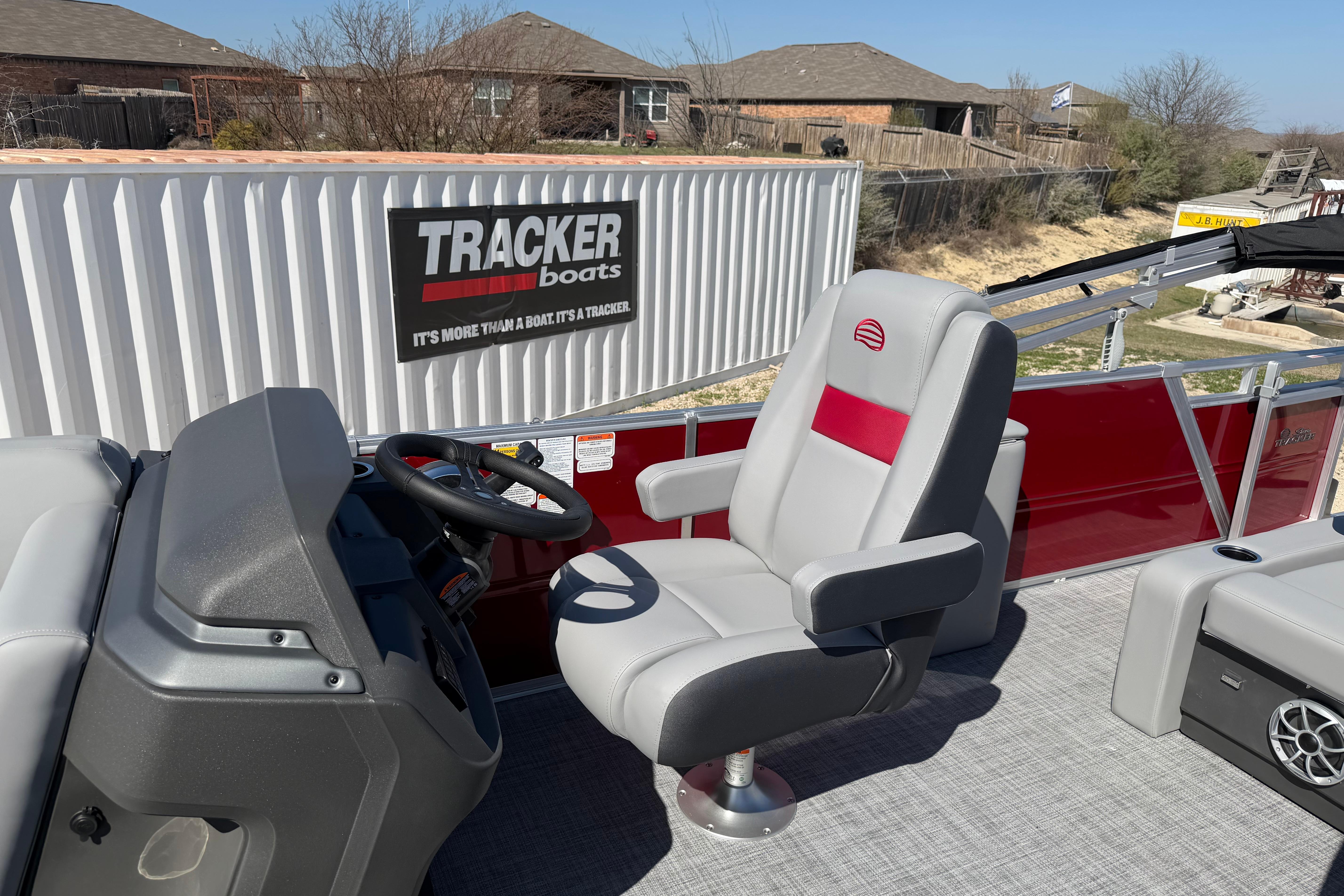 2026 Sun Tracker Party Barge 22 RF XP3 interior with captain's chair and steering console.