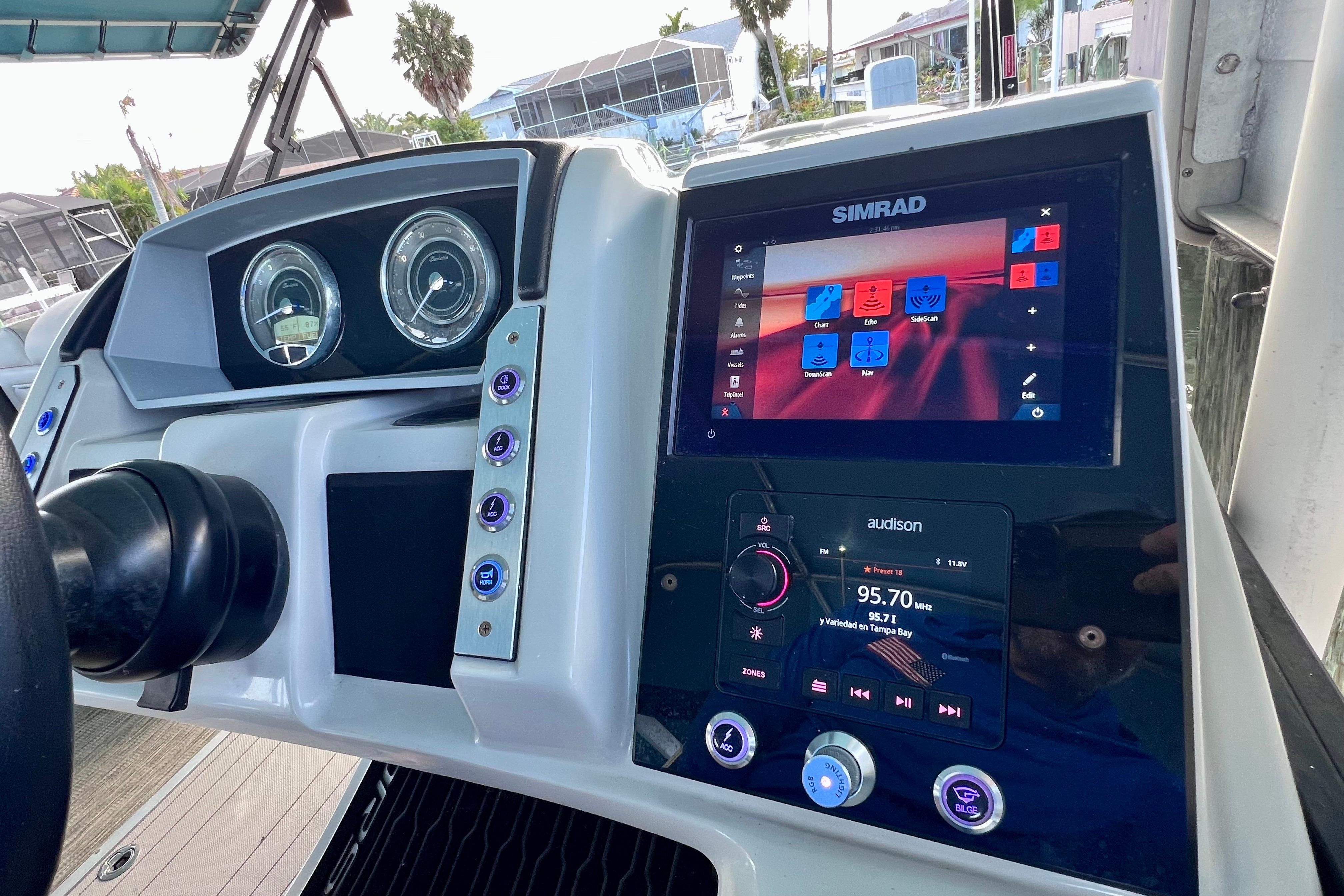 2023 Barletta Corsa 23UC boat dashboard with Simrad and Audison displays.