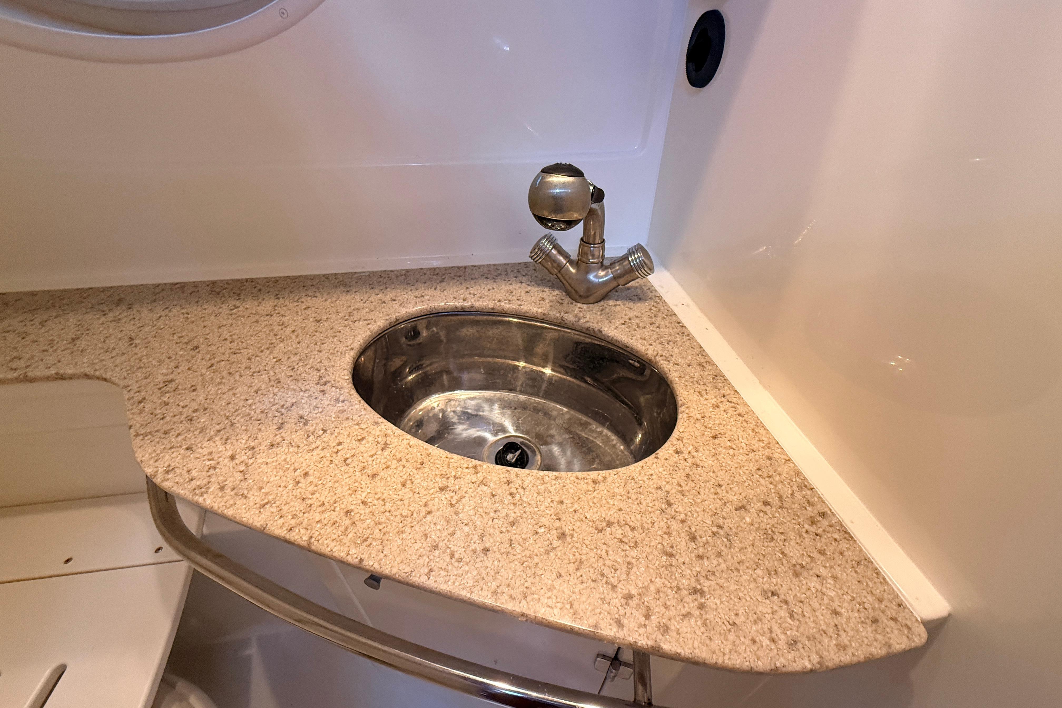2011 Monterey 320 Sport Yacht bathroom sink with granite countertop and modern faucet.