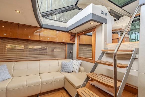 Luxurious interior of 2016 Sea Ray Sundancer 510 yacht with plush seating and wooden stairs.