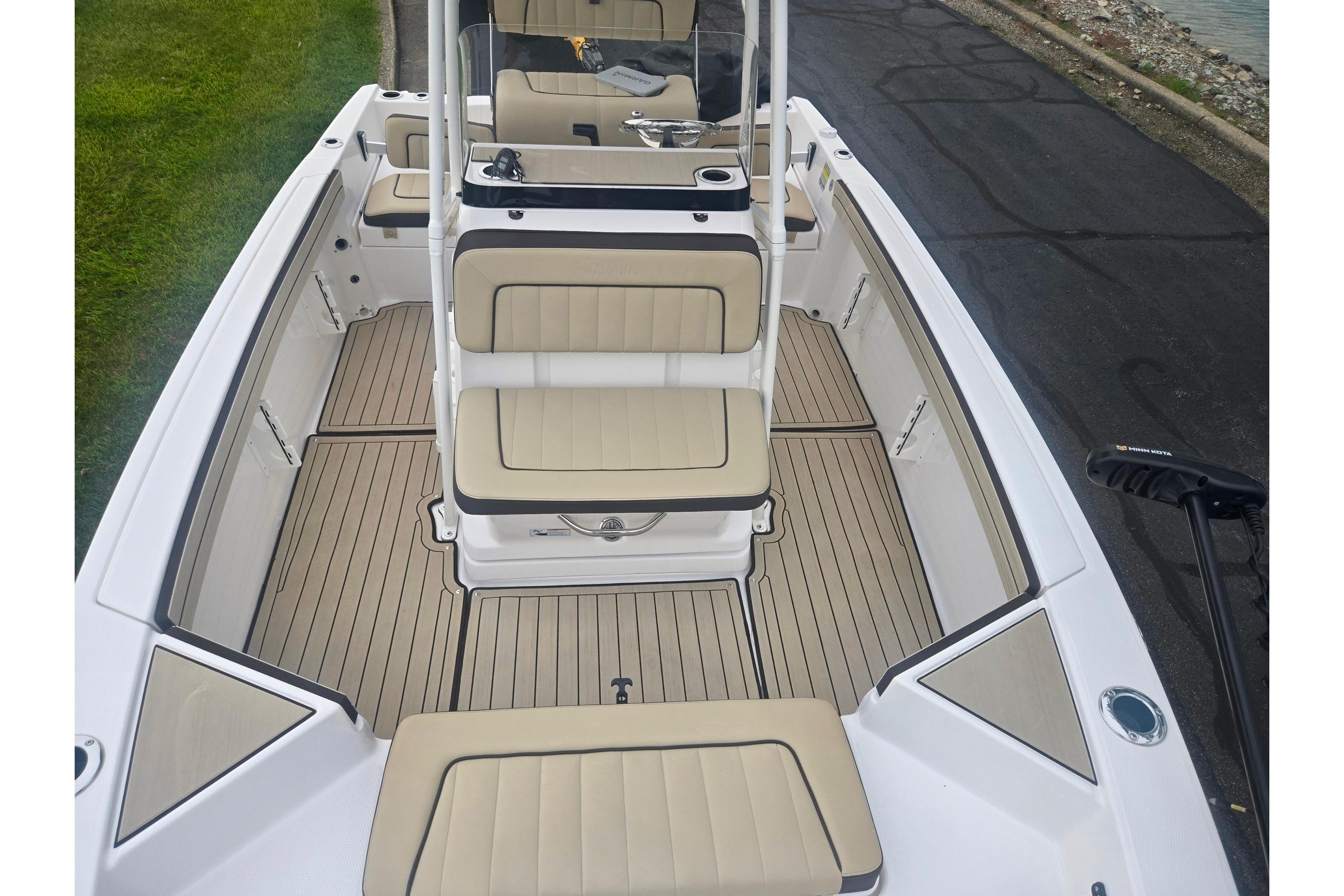 2022 Yamaha Boats 195 FSH Sport interior with beige seating and sleek design.