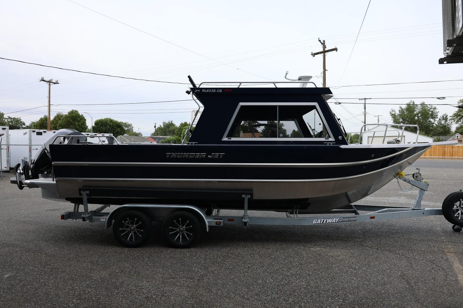 2026 Thunder Jet 24 Alexis Pro boat on trailer, parked outdoors.