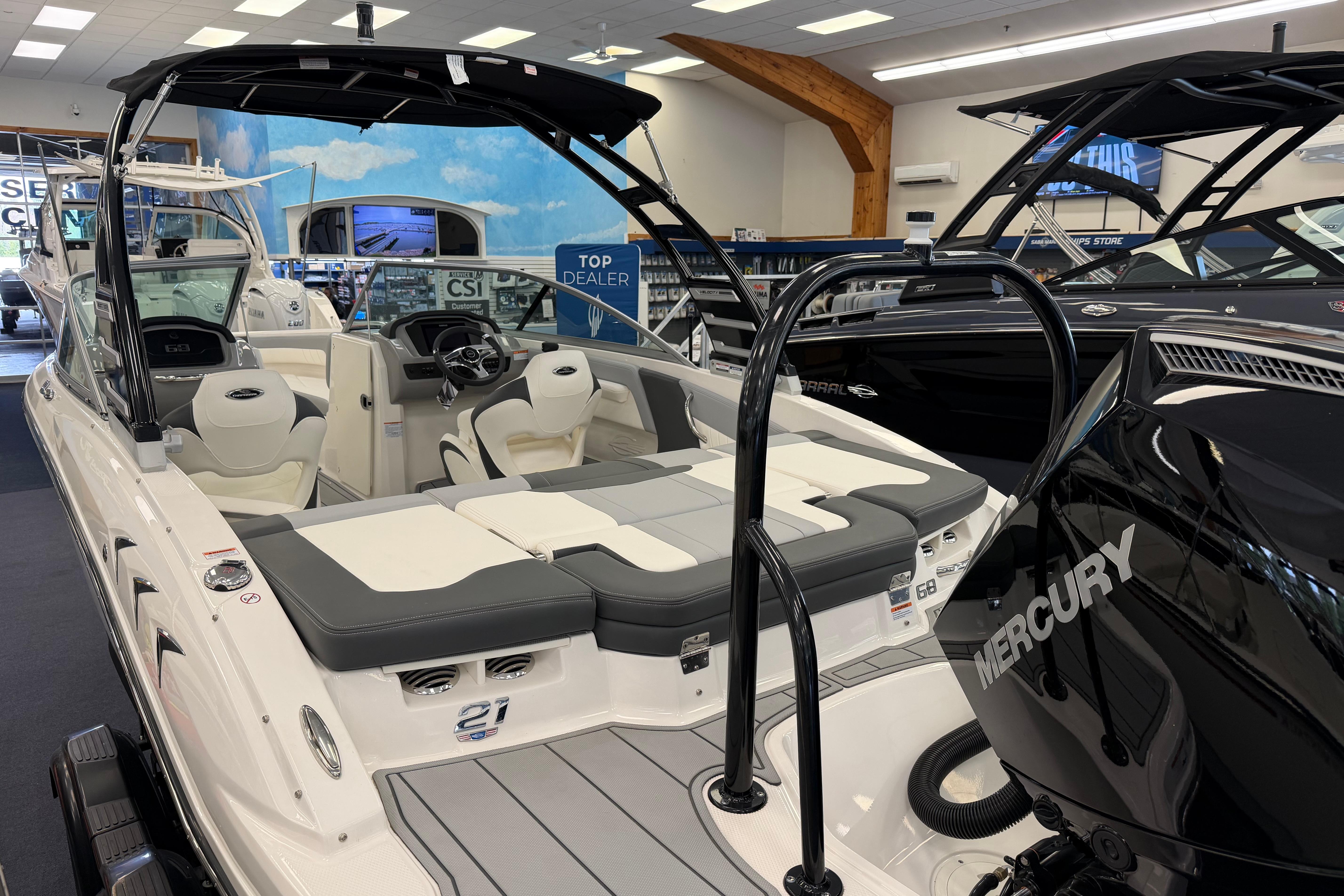 2025 Chaparral 21 SSi OB boat with Mercury engine in showroom display.