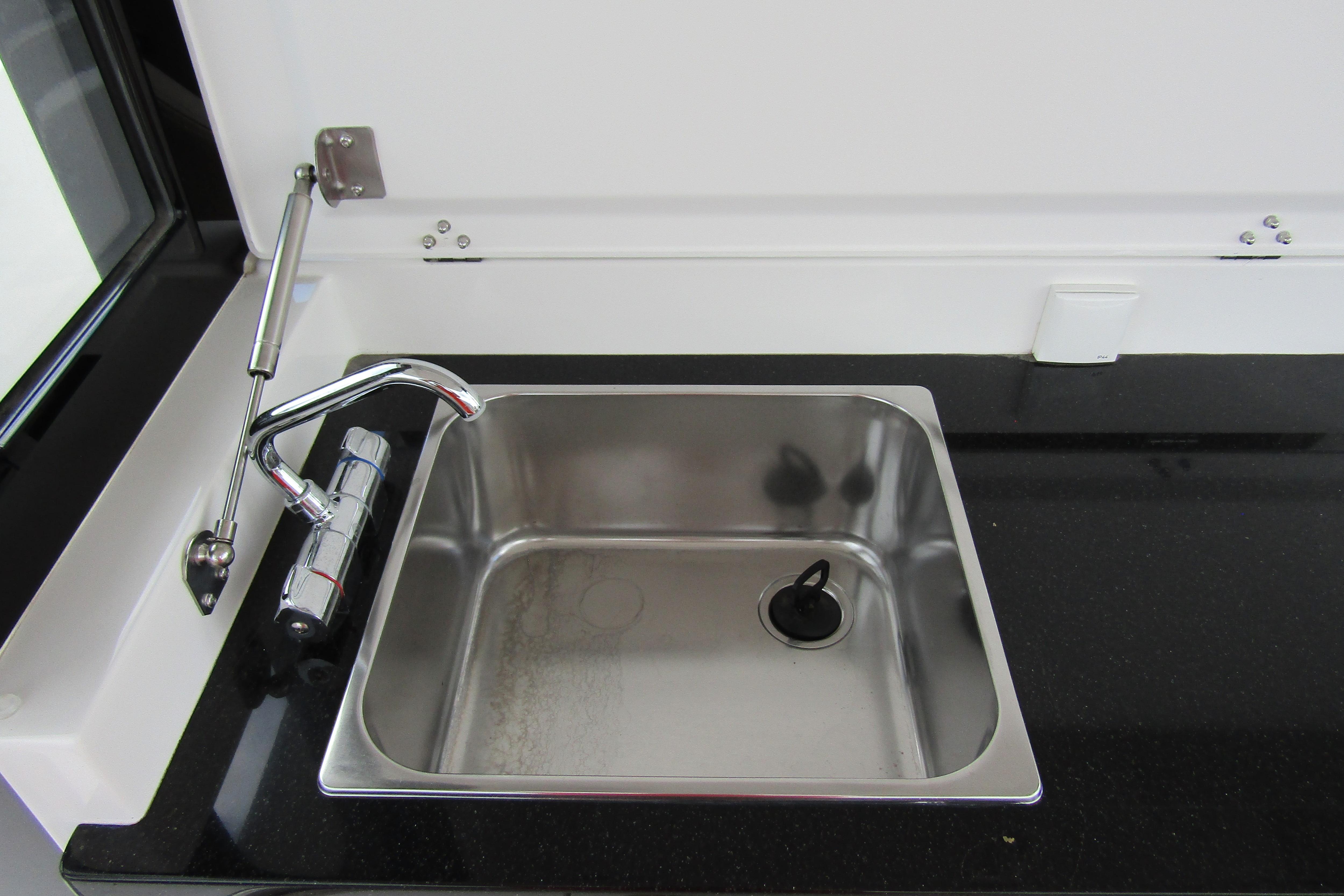 Stainless steel sink with modern faucet in 2025 Nimbus Tender 11 boat.