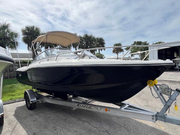 2021 Scout 210 Dorado boat on trailer with canopy, parked outdoors.