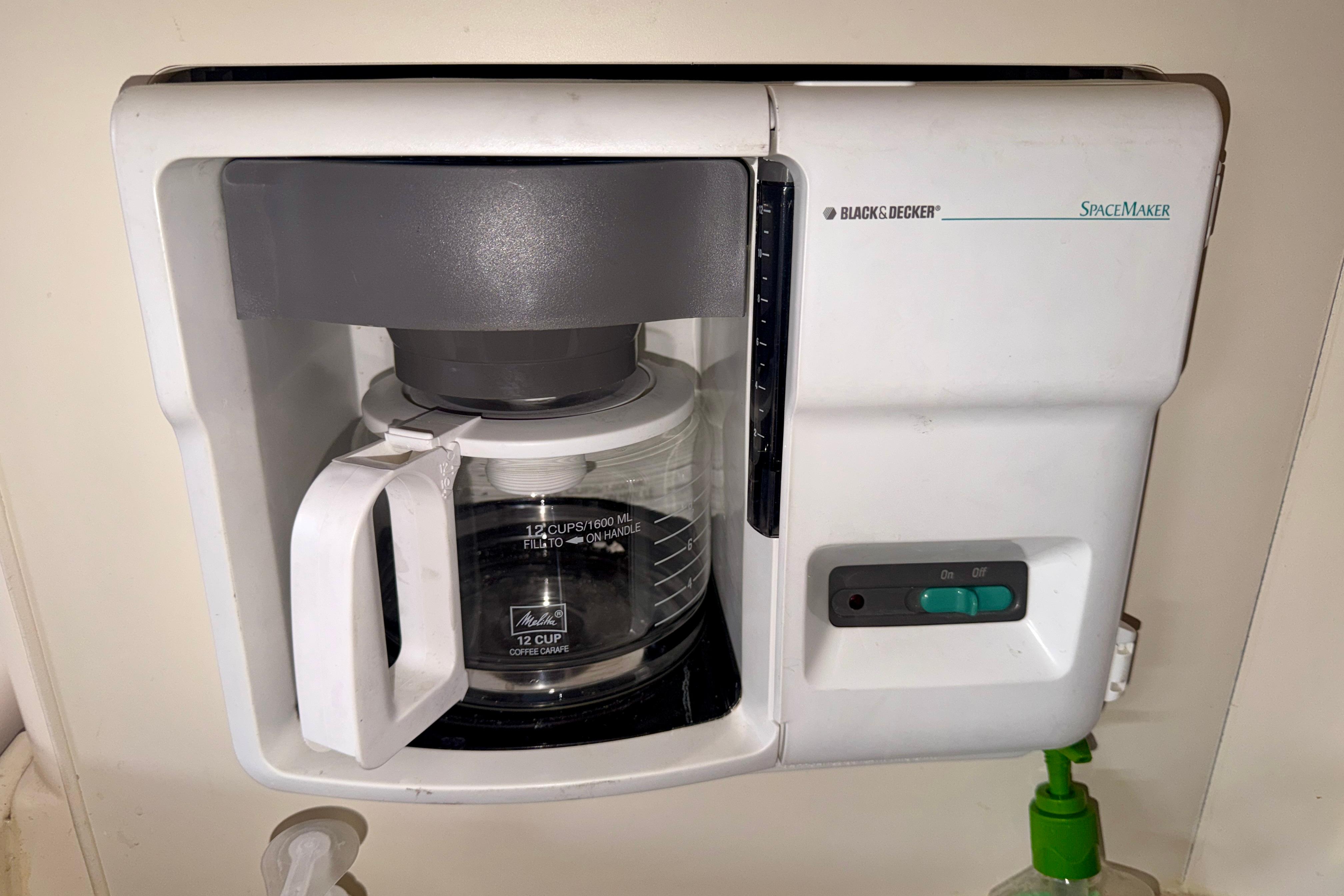 Black & Decker SpaceMaker coffee maker with 12-cup carafe, mounted under a cabinet.