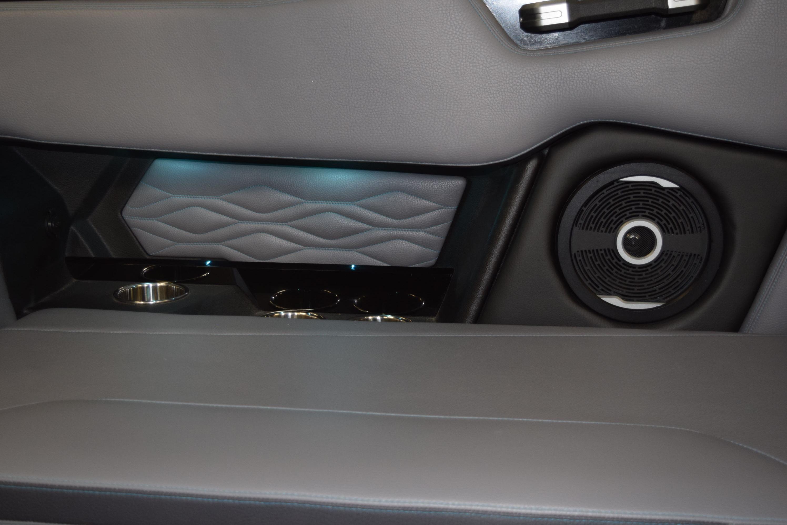 2026 Supra SL 550 interior detail with speaker, cup holders, and ambient lighting.