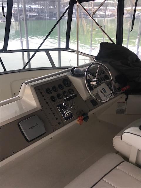 1996 Carver 370 boat helm with steering wheel and control panel.