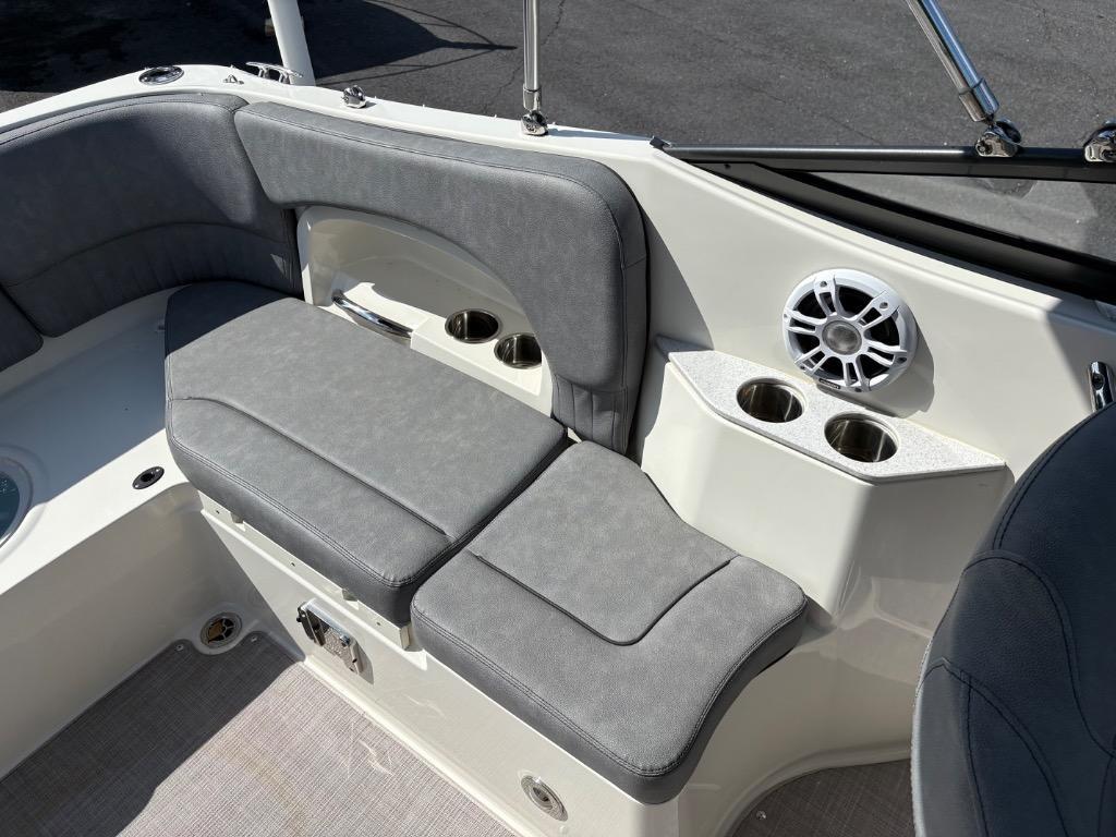 2021 Stingray 231 DC boat interior with gray seating, cup holders, and speaker.