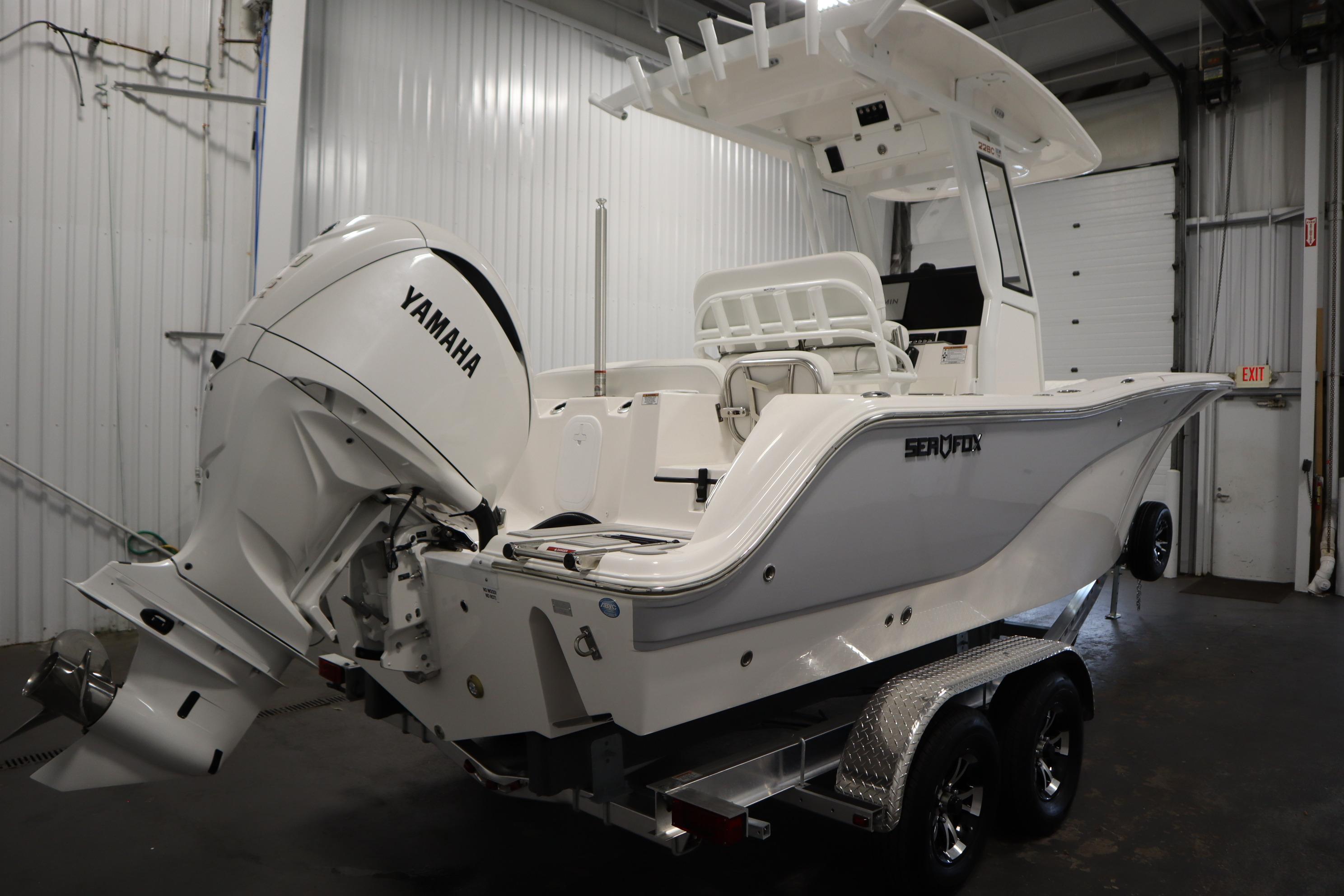 2026 Sea Fox 228 Commander boat with Yamaha engine in a garage setting.
