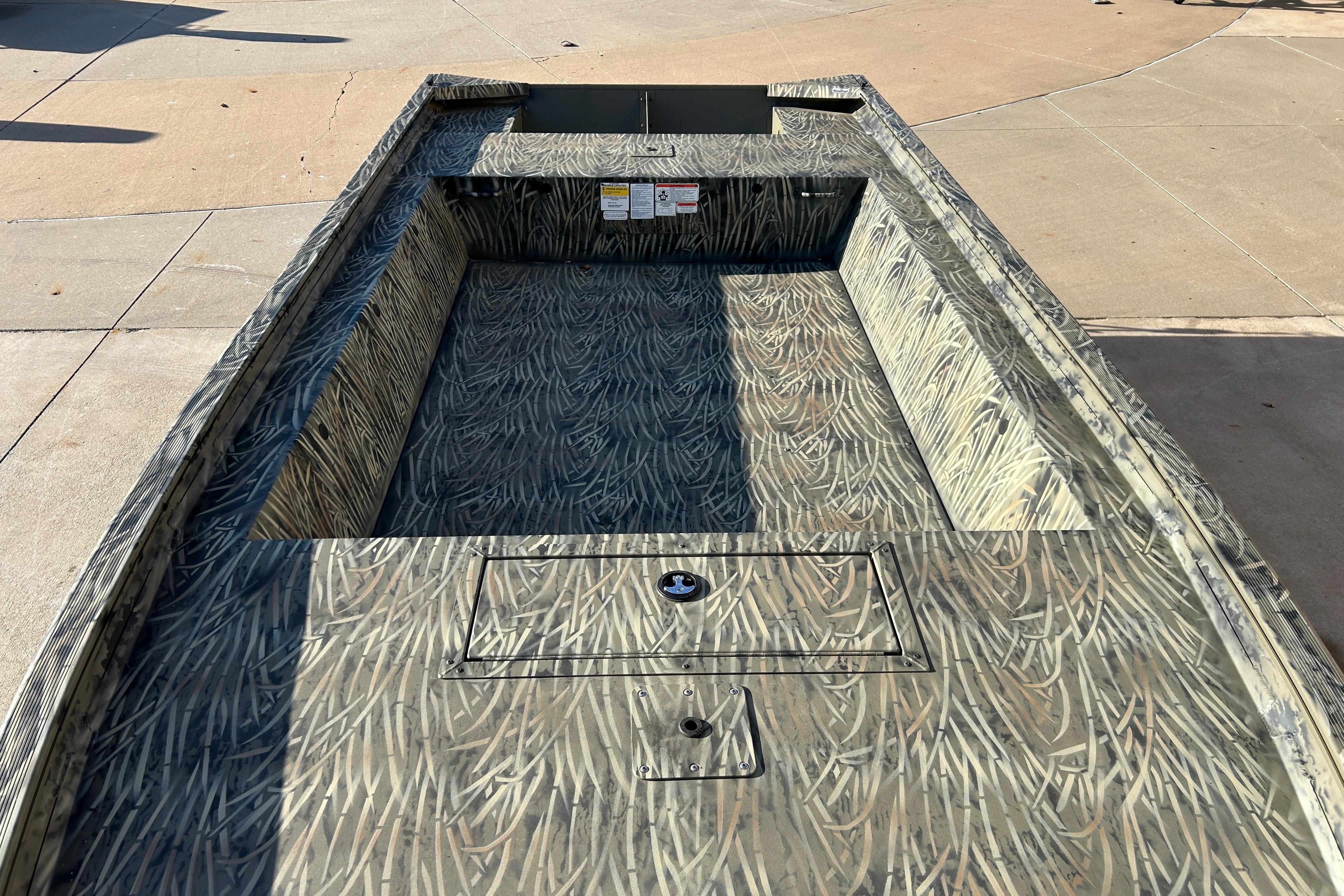 2026 Tracker Grizzly 1754 Utility boat with camouflage interior design.