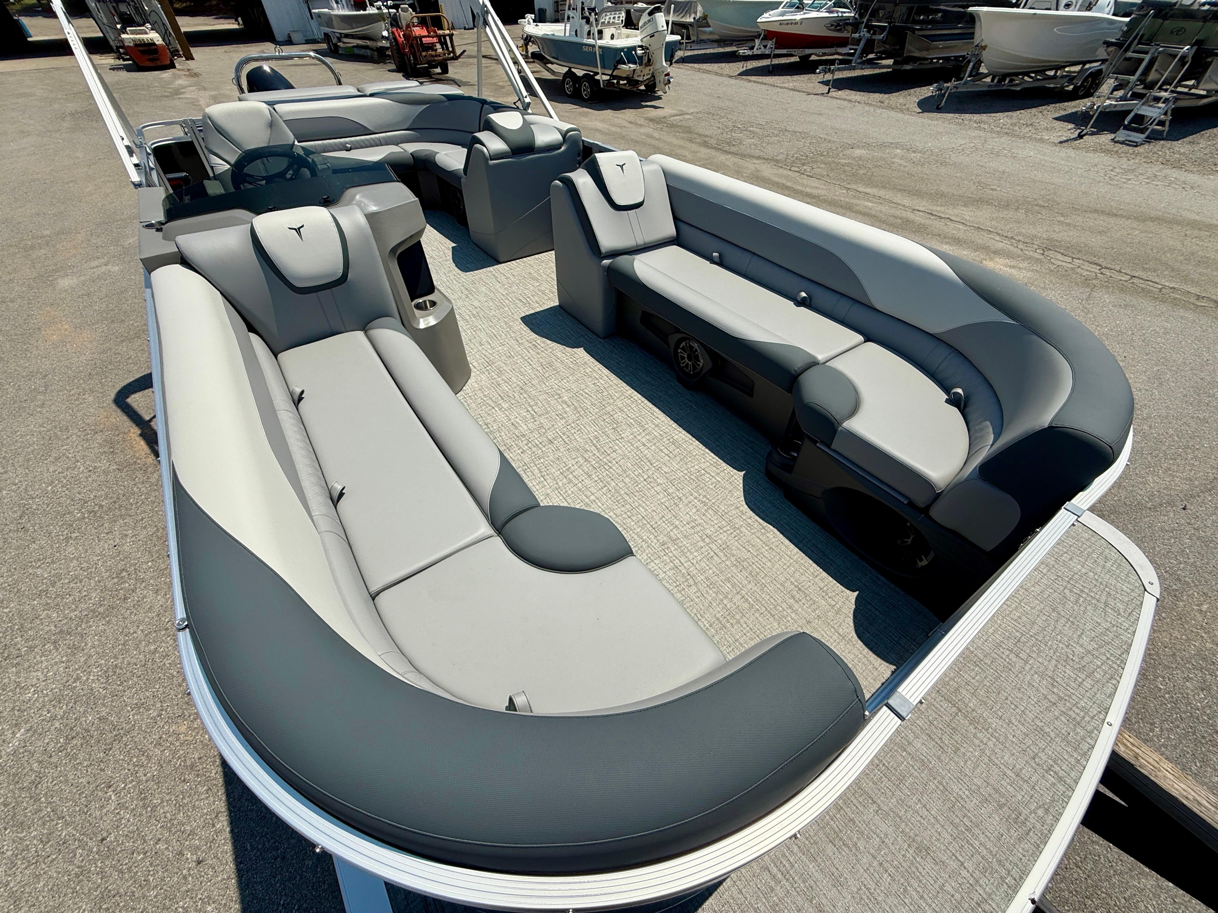 2025 Tahoe Pontoon LTZ Cruise with spacious seating and modern design in a boatyard.