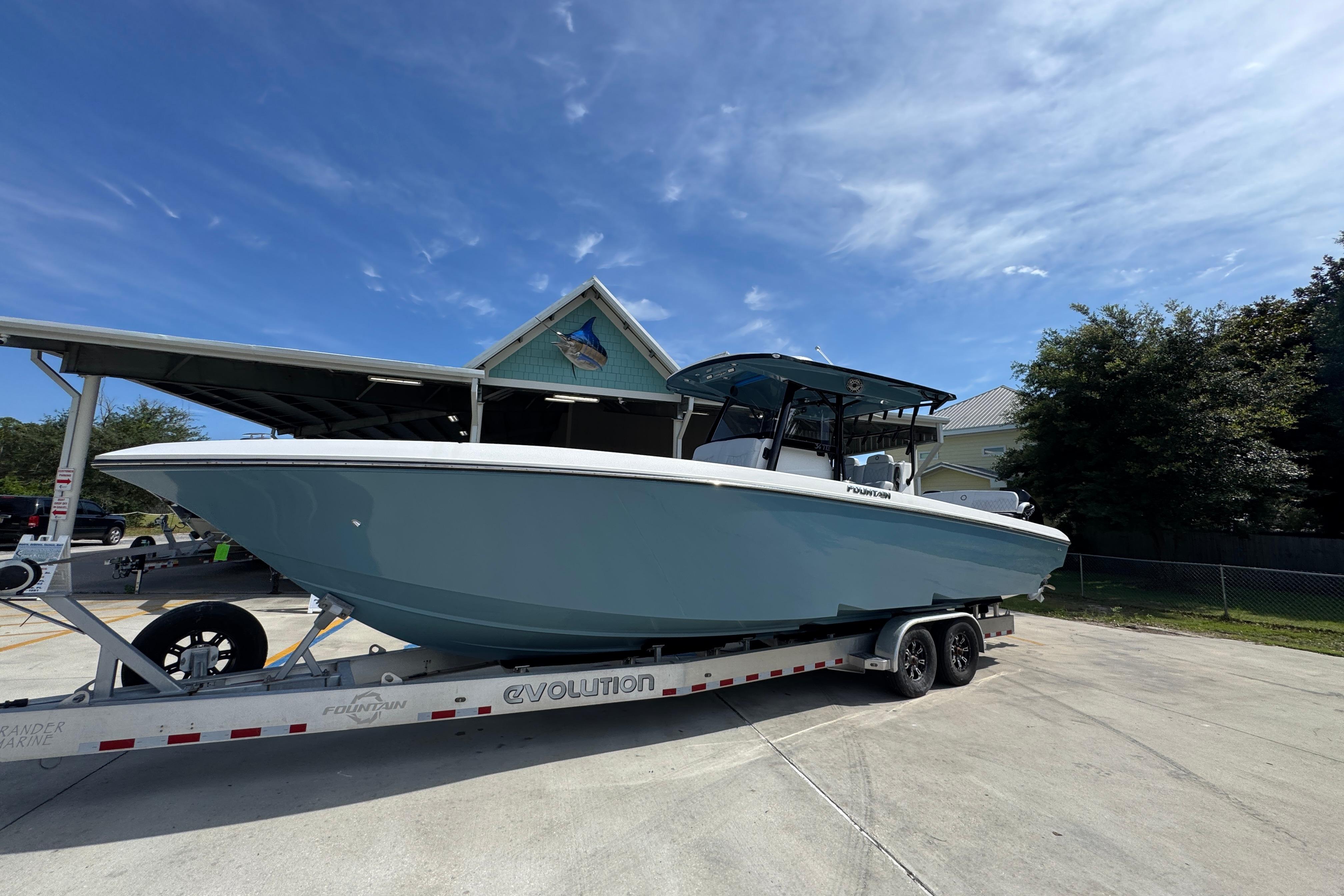 2023 Fountain 34 Tournament Edition boat on trailer under clear blue sky.