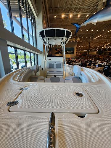 2025 Mako 214 CC boat displayed indoors, showcasing spacious deck and seating.