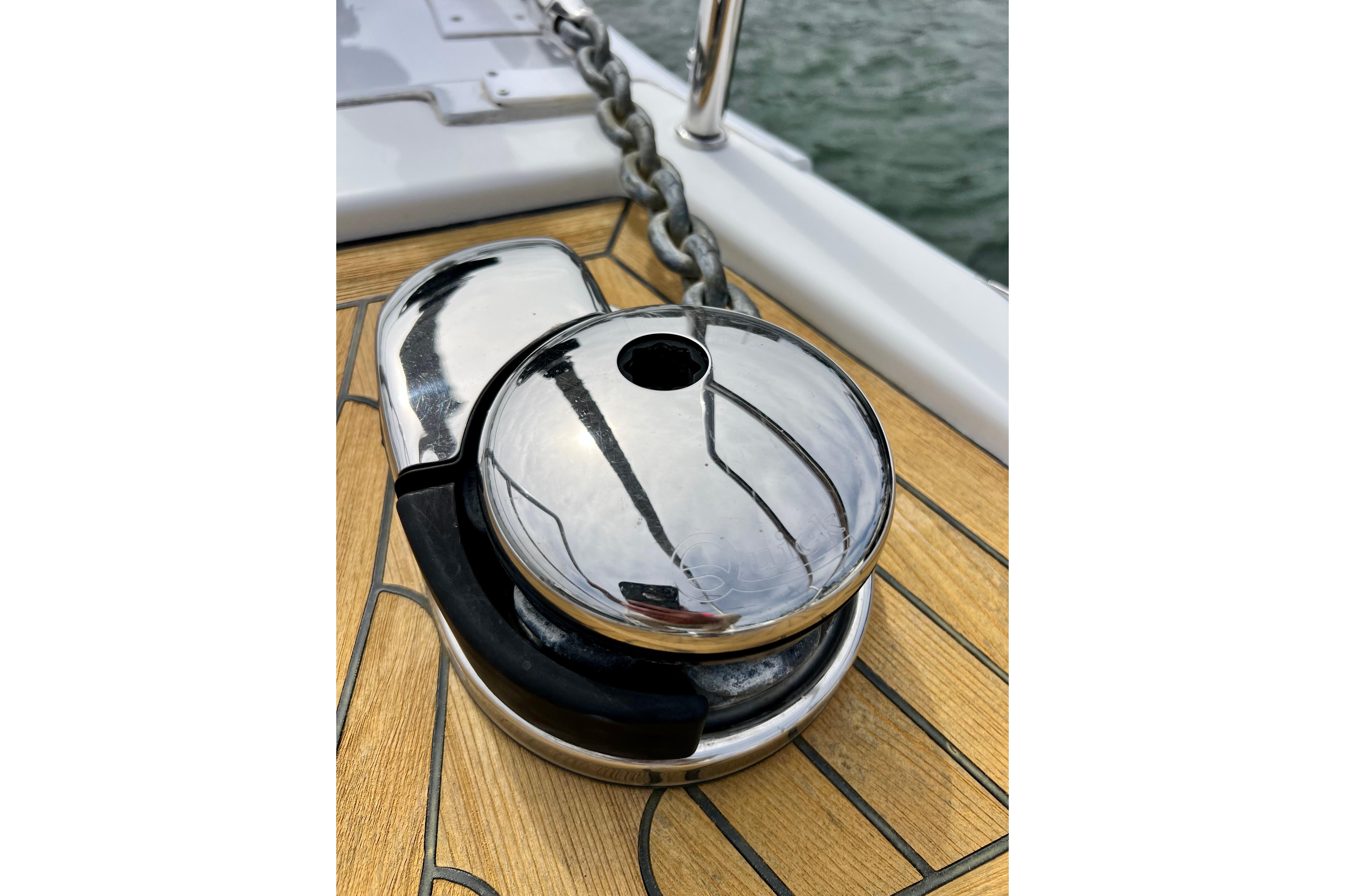 Chrome winch on 2016 Hanse 455 yacht deck with chain, near water.