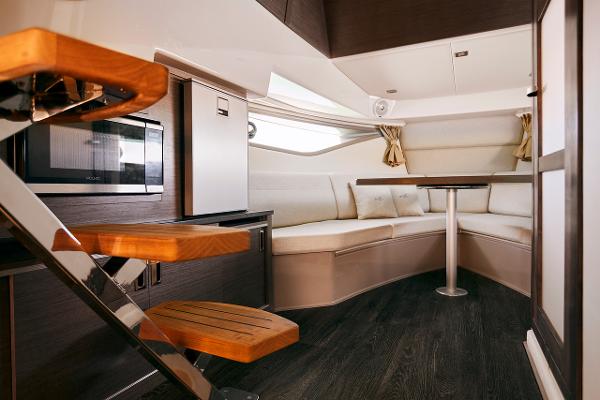 Manufacturer Provided Image: Interior of 2023 Sea Ray Sundancer 320 yacht with modern seating and wooden stairs.