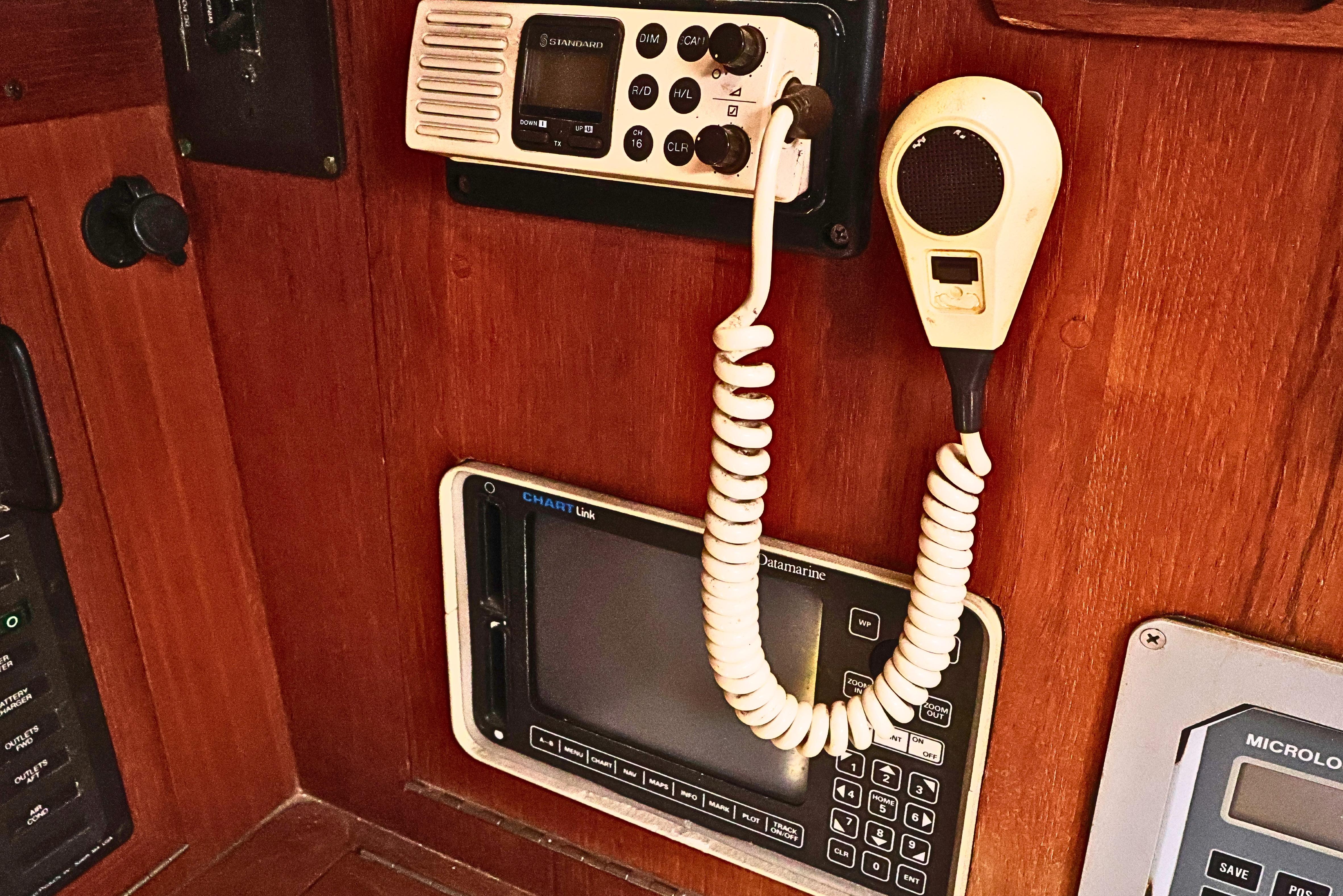 1989 J Boat J 40 navigation equipment with radio and control panel on wooden interior.
