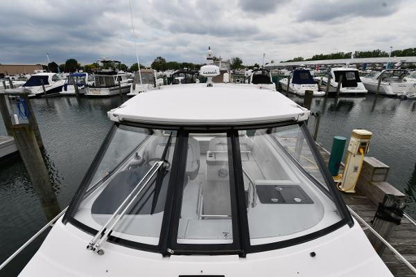 2021 Regal 35 Sport Coupe docked at a marina under cloudy skies.